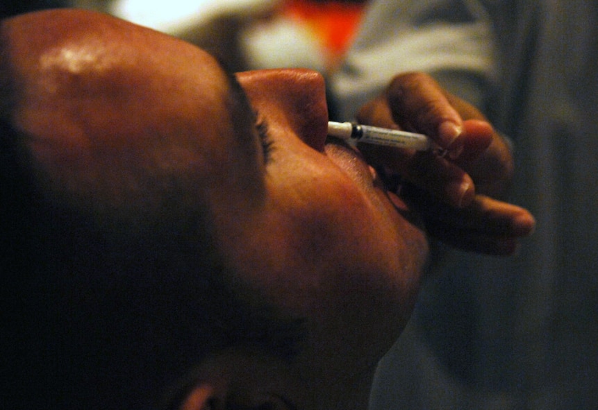 MOODY AIR FORCE BASE, Ga. – Tech Sgt. Michael Sherry, 822nd Security Forces Squadron squad leader, is administered flu mist here Oct. 07. The live influenza strand was administered by Sheila Stacks, 23rd Medical Group registered nurse from the 23rd Medical Group clinic. (U.S. Air Force photo by Airman Joshua Green)