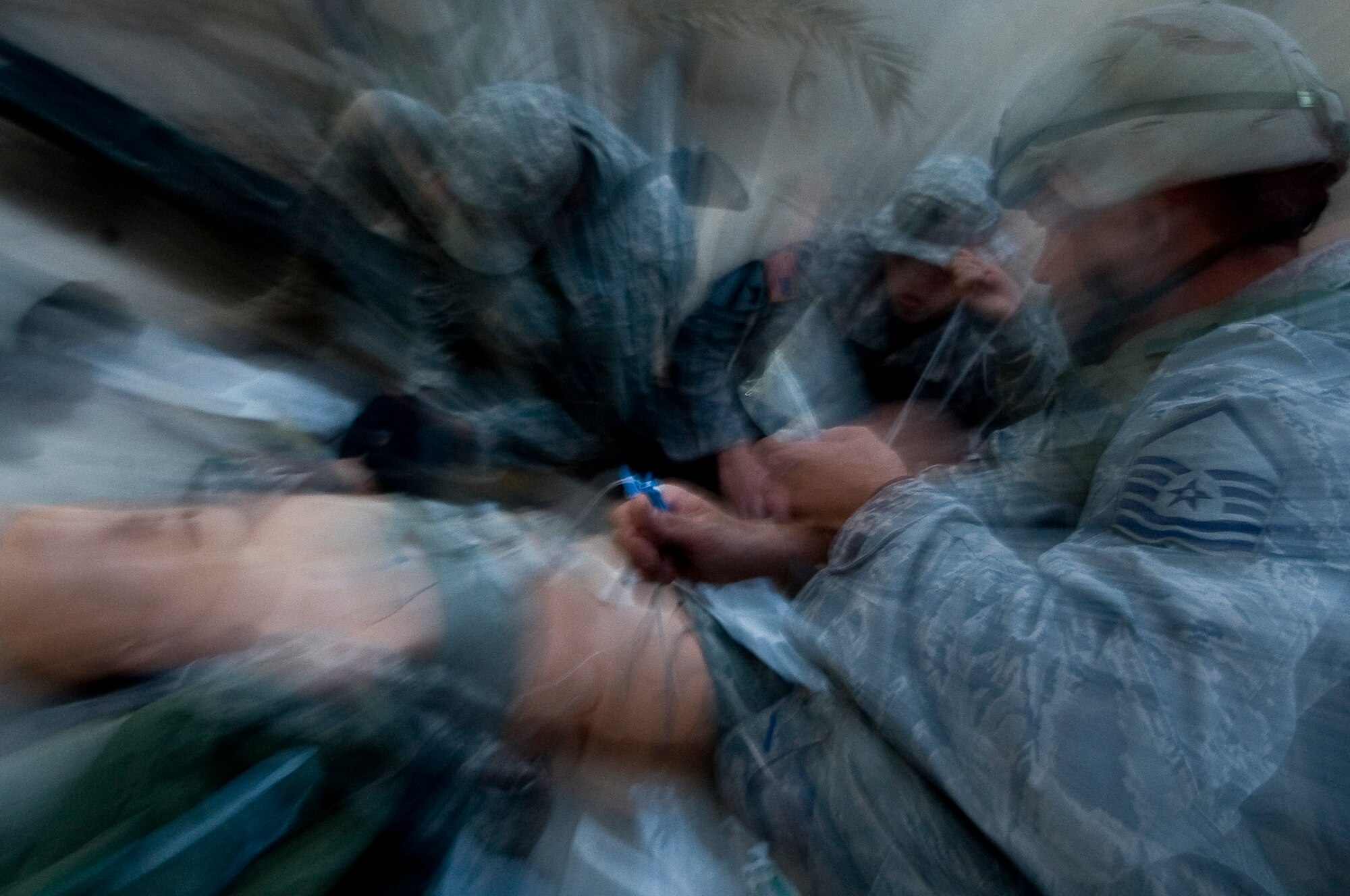ALI BASE, Iraq -- Master Sgt. Peter Winetroub, 407th Air Expeditionary Group anti-terrorism officer, runs an IV injured through victim during their combat lifesaver final exam Oct. 9, 2008. Army and Air Force members attended a combat lifesaver course, for the final exam each class team ran through a scenario putting the skills they learned to the test. Winetroub is deployed from Shaw Air Force Base, S.C. (U.S. Air Force photo/Senior Airman Christopher Griffin) 