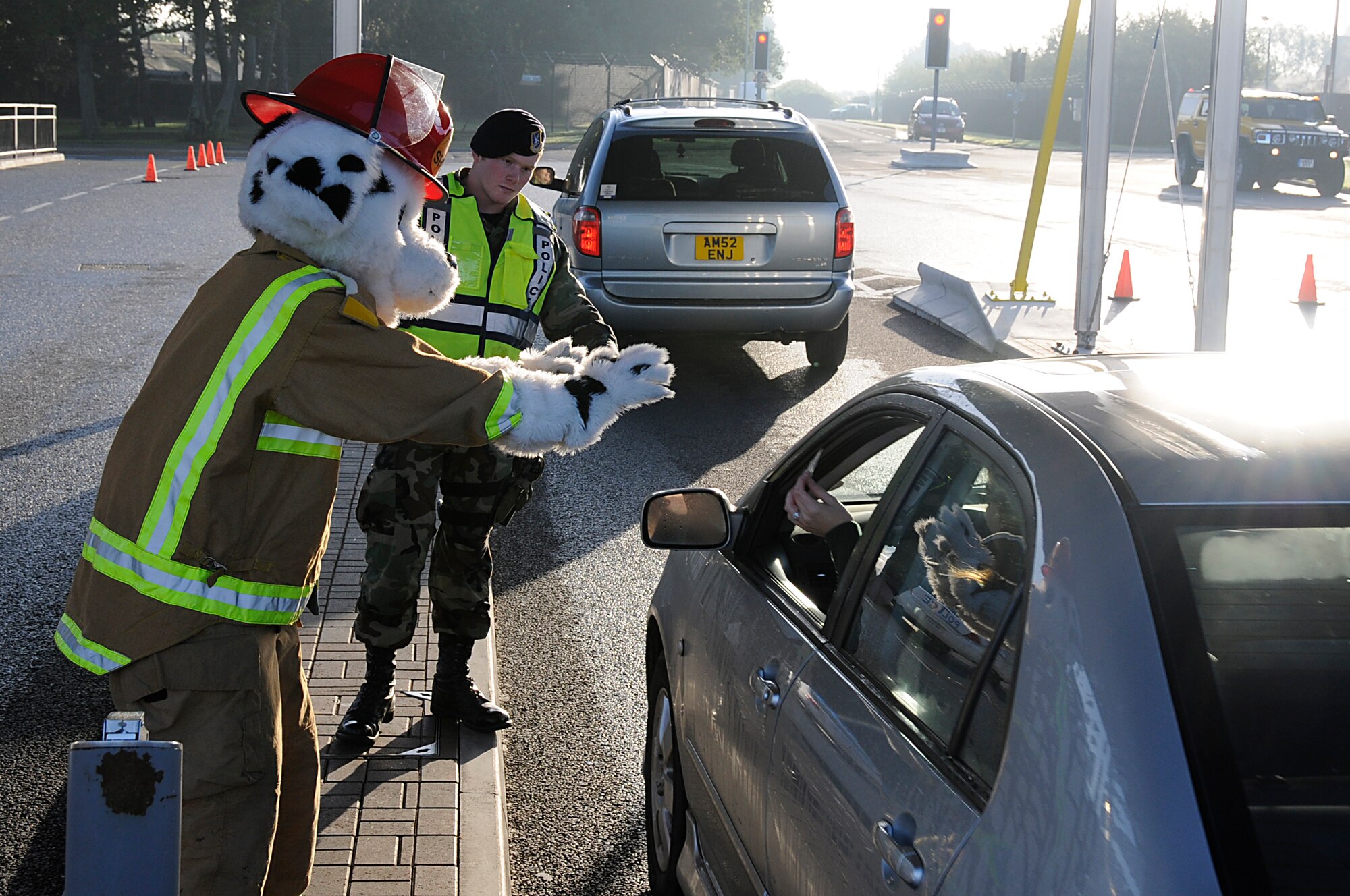 Sparky the fire dog greets people as they come onto RAF Lakenheath, England, Oct. 6. Sparky made appearances at both of RAF Lakenheath's two gates kicking off Fire Prevention Week. (U.S. Air Force photo by Senior Airman Brian J. Ellis)