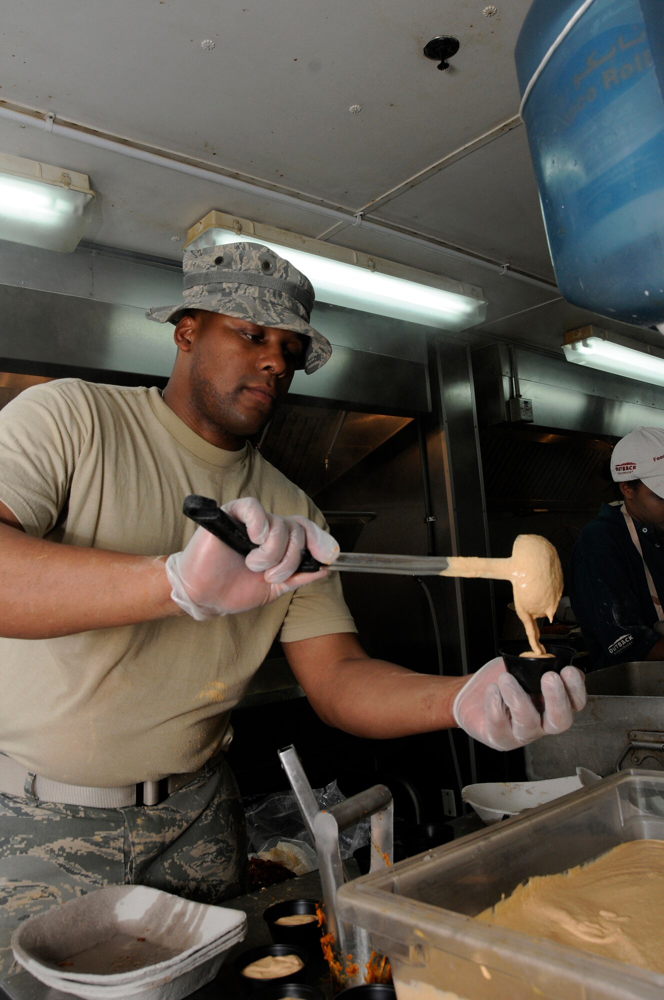 Tech. Sgt. Marvin Rhodeman, 379th Expeditionary Force Support Squadron, prepares the Bloomin' sauce for the center piece of a Bloomin' Onion platter October 9, 2008. The Bloomin' Onion is breaded, and then fried with technical support from employees of the Outback Steakhouse at an undisclosed air base in Southwest Asia.  The Outback brought in food and expertise in a show of support for U.S. troops supporting Operations Iraqi and Enduring Freedom and Joint Task Force-Horn of Africa.  (U.S. Air Force photo by Tech. Sgt. Michael Boquette/Released)