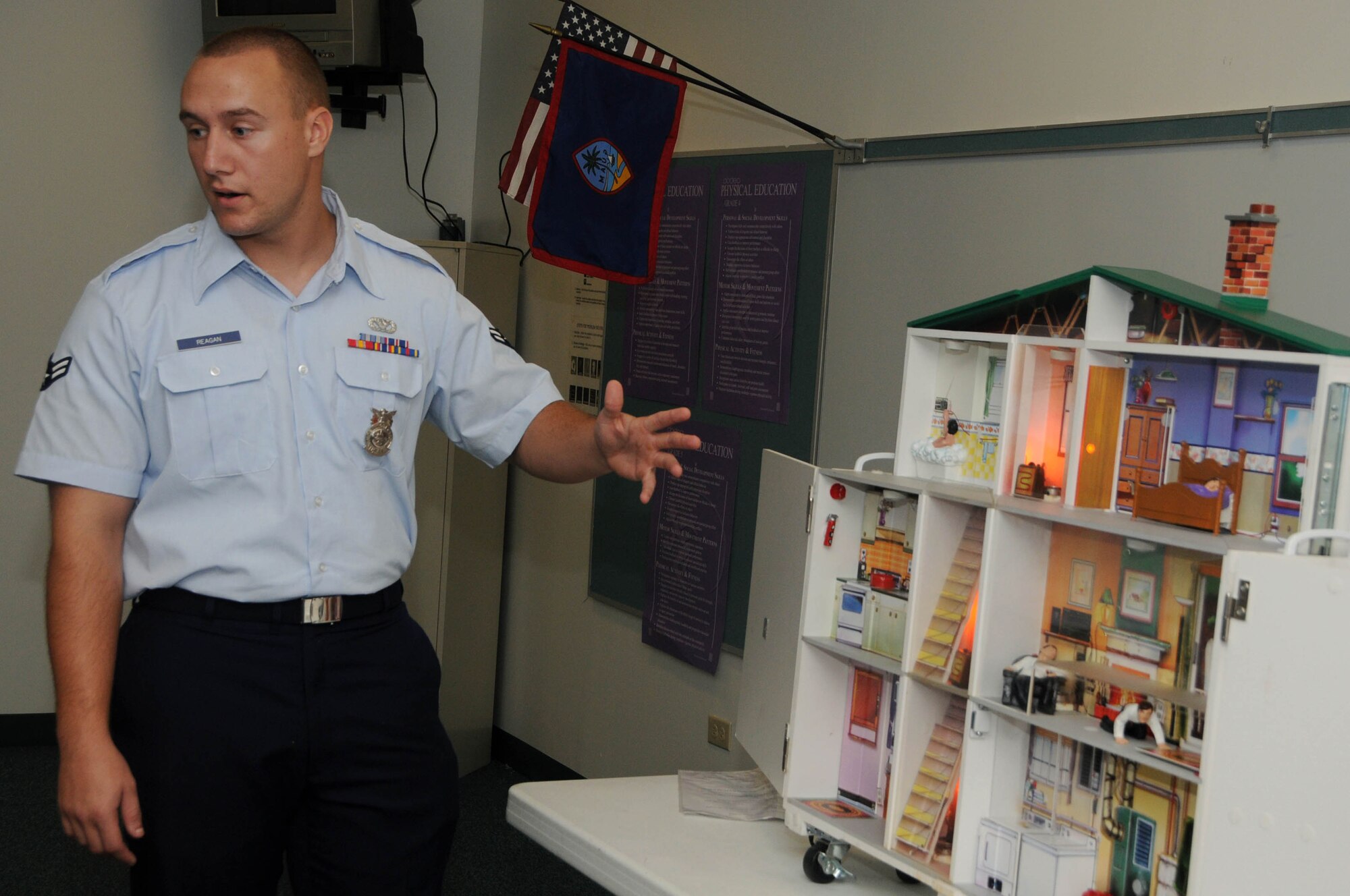 ANDERSEN AIR FORCE BASE, Guam - Airman 1st Class Sean Reagan, 36th Civil Engineer Squadron firefighter, explains to Andersen Elementary School students how water and appliances can cause safety mishaps during Fire Prevention Week here Oct. 9. Fire Prevention Week is held once per year, but firefighters can be scheduled to perform briefings throughout the year upon request. (U.S. Air Force photo by Senior Airman Sonya Croston)