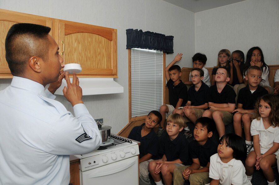 ANDERSEN AIR FORCE BASE, Guam - Staff Sgt. Roderick Marquez, fire fighter, 36th Civil Engineer Squadron, educates children from Andersen Elementary School on the purpose of a smoke detector. Fire prevention week is an annual event that was held Oct. 5-11. (U.S. Air Force photo by/Senior Airman Sonya Croston)