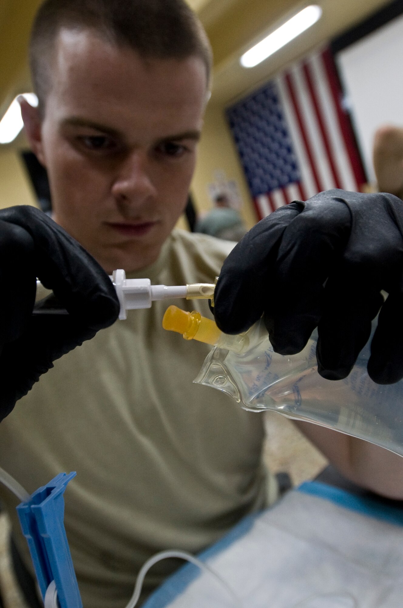 ALI BASE, Iraq -- Senior Airman Robert Aten, 407th Air Expeditionary Group Public Affairs broadcaster, prepares a saline pouch for use during the combat lifesaver course Oct. 7, 2008. Army and Air Force members attended a five-day combat lifesaver course here Oct. 6-10. The course addresses preventable combat deaths to include blast injury, amputation, severe bleeding, airway management and evacuation techniques. Aten is deployed from Elmendorf Air Force Base, Alaska. (U.S. Air Force photo/Senior Airman Christopher Griffin)