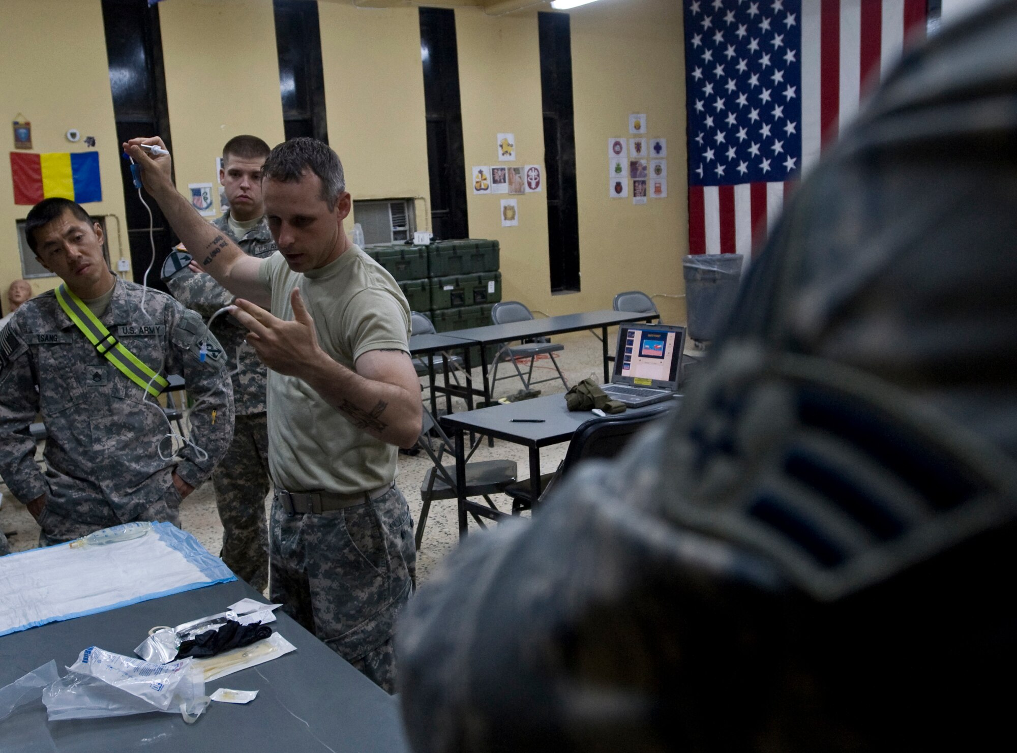 ALI BASE, Iraq -- Army Sgt. Christopher Payne, Headquarters Company 7th Sustainment Brigade assistant medical instructor, shows students the equipment they will be using when inserting an IV Oct. 7, 2008. Army and Air Force members attended a combat lifesaver course, a cross between the first aid (self-aid/buddy aid) and the medical training given to the combat medics. Payne is deployed from Fort Eustis, Va. (U.S. Air Force photo/Senior Airman Christopher Griffin) 