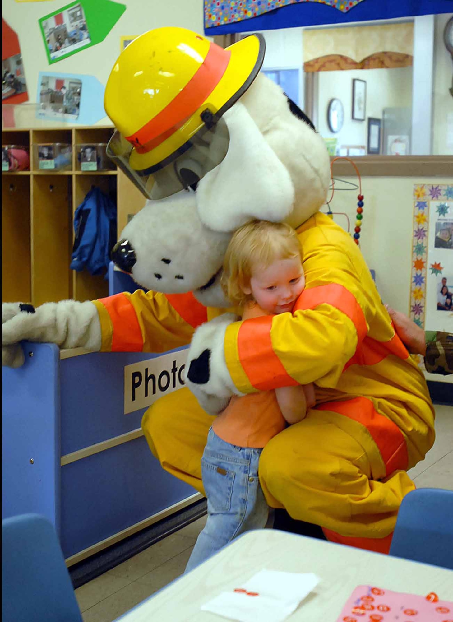 OSAN AIR BASE, Republic of Korea -- Sparky the Fire Dog gives a hug at the Osan Child Development Center. Sparky and the local fire department made the visit during Fire Prevention Week. (U.S. Air Force photo/Master Sgt. Marlin Zimmerman)