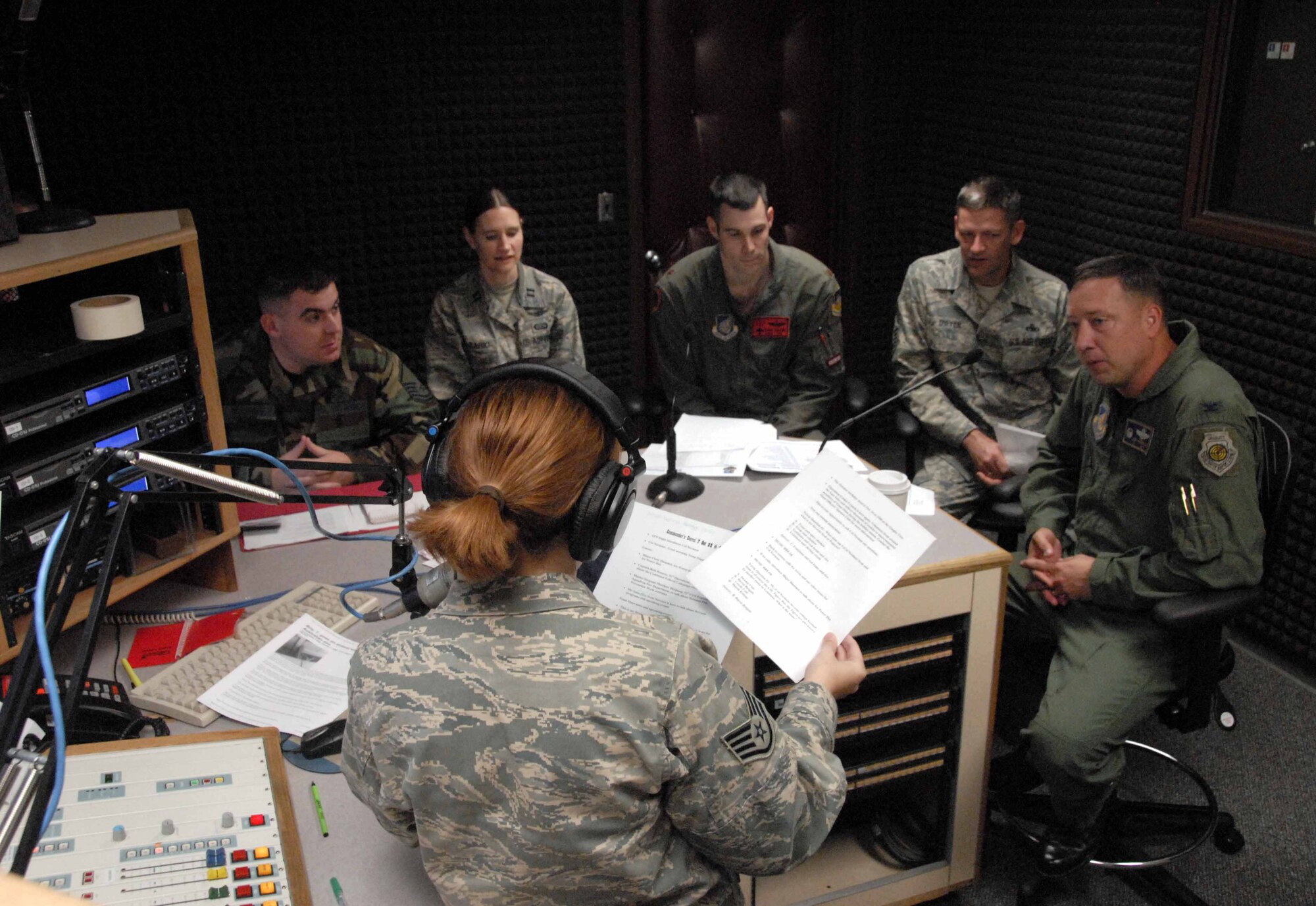 OSAN AIR BASE, Republic of Korea -- Staff Sgt. Joy Meek, American Forces Network broadcaster, (with headphones), conducts the final Commander's Corral Radio Show for Col. Jon Norman, 51st Fighter Wing commander, (far right) at the AFN detachment Oct. 7. (U.S. Air Force photo/Master Sgt. Matt Summers)