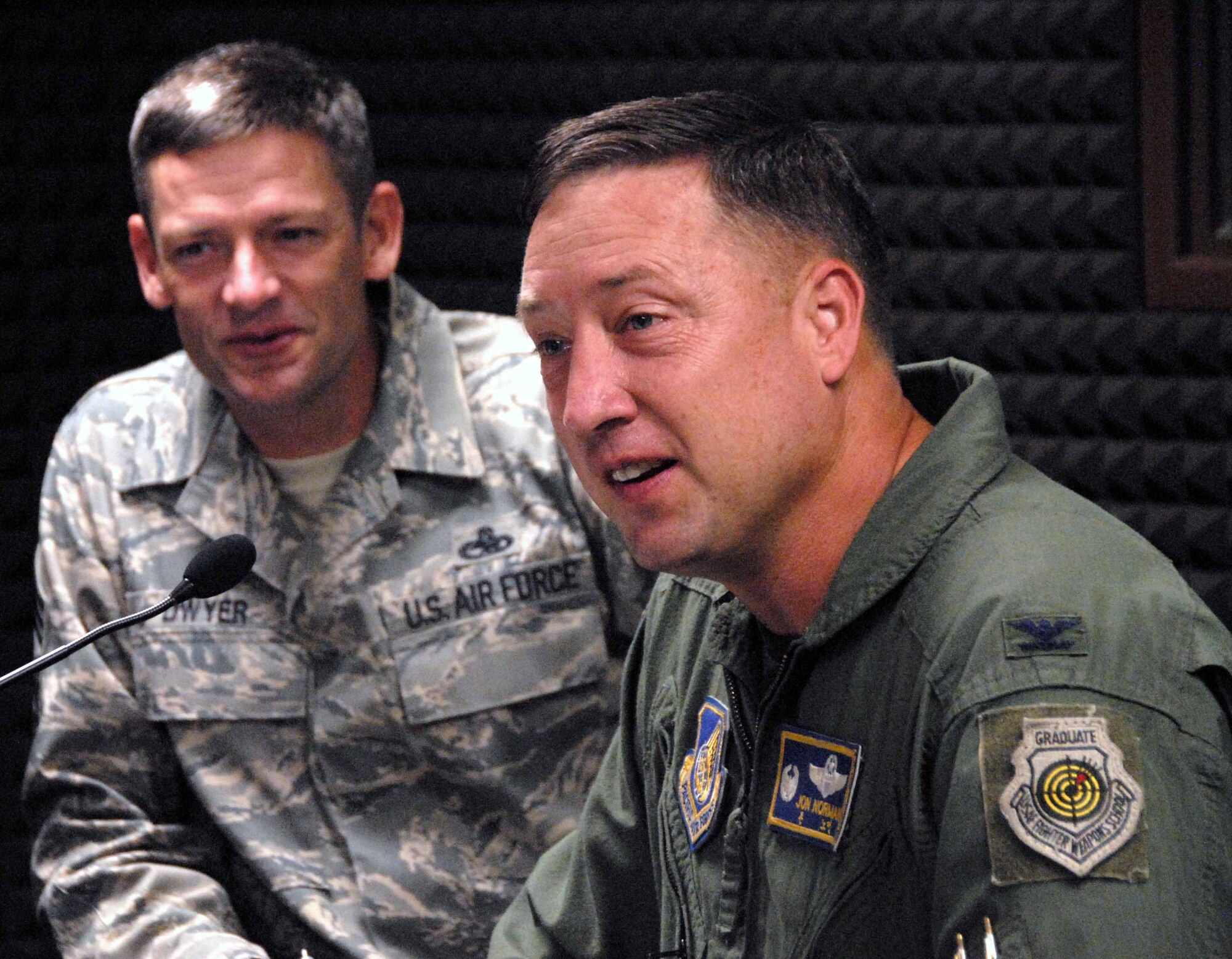 OSAN AIR BASE, Republic of Korea -- Col. Jon Norman, 51st Fighter Wing commander, and Chief Master Sgt. Darrin Dwyer, 51st FW command chief, take part in the colonel’s final Commander’s Corral Radio Show at the American Forces Network detachment Oct. 7. The colonel will leave Osan to become the executive officer for the Chief of Staff of the Air Force. 