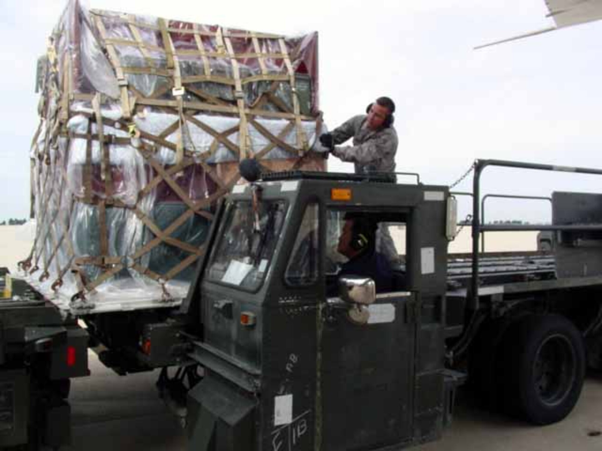 KUNSAN AIR BASE, Republic of Korea --Members of the 731st Air Mobility Squadron load cargo onto aircraft. Twenty-five personnel from the 731st Air Mobility Squadron temporary “deployed” to Kunsan Air Base, Republic of Korea, Sept. 21 Sept to Oct. 1, for a training event designed to enhance the unit’s mission capabilities and efficiency. (U.S. Air Force photo) 