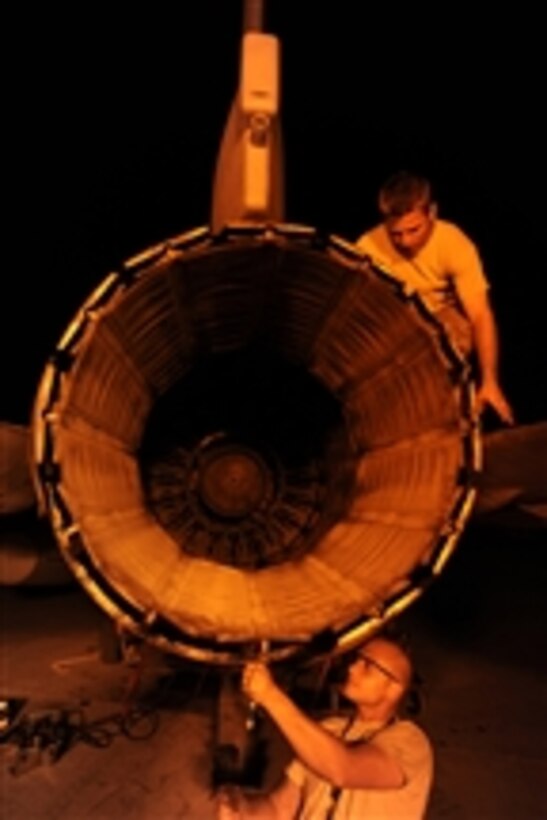 U.S. Air Force Staff Sgt. Danny Shaw (top) actuates an exhaust nozzle as Staff Sgt. Nathan Gadbois installs safety wiring around bolts on an F-16 Fighting Falcon aircraft at Joint Base Balad, Iraq, on Oct. 6, 2008.  Both airmen are aerospace propulsion journeymen with the 332nd Expeditionary Aircraft Maintenance Squadron.  