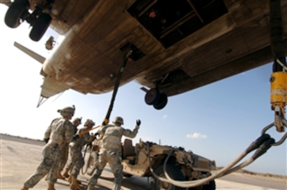 U.S. soldiers from 2nd Battalion, 18th Field Artillery Regiment, practice sling loading a helicopter from Marine Heavy Helicopter Squadron 464, Oct. 9, 2008, during training at an airstrip outside of Camp Lemonier, Djibouti. Both units are deployed to Combined Joint Task Force - Horn of Africa. 
