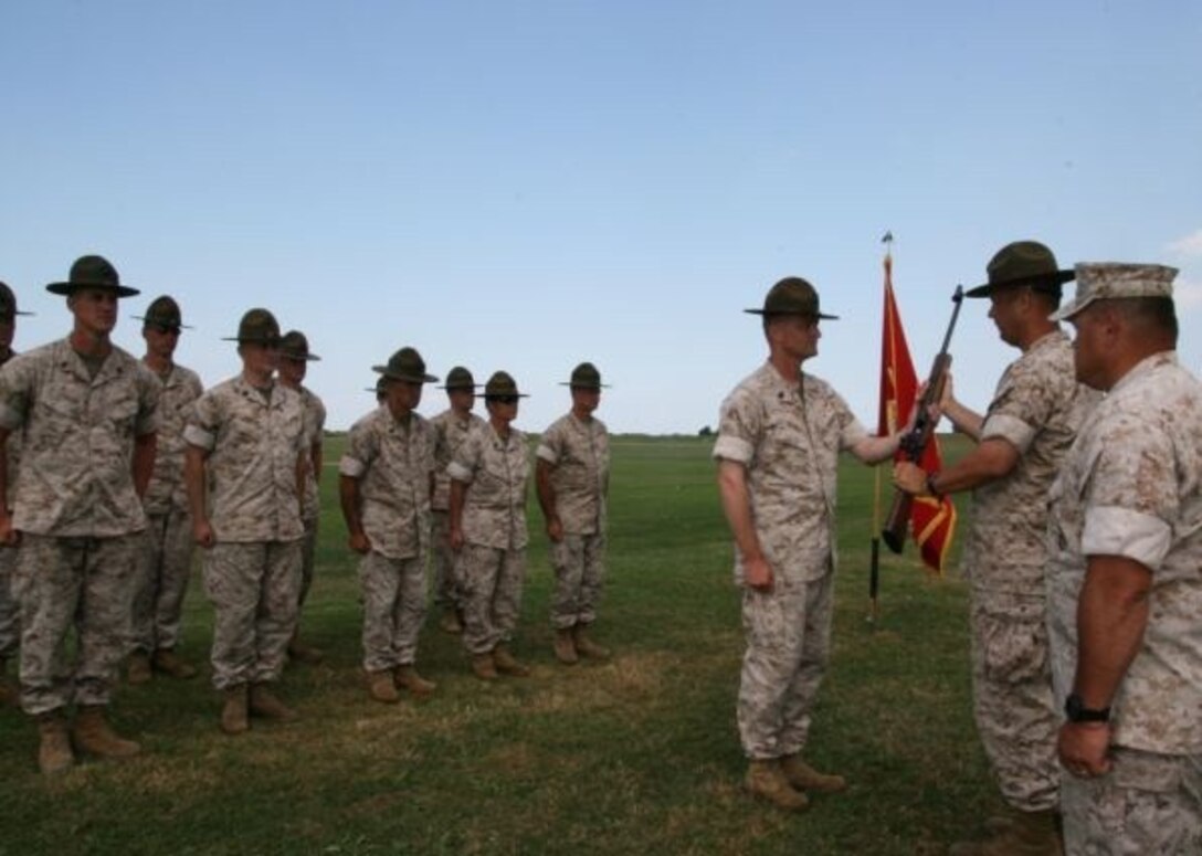 At the National Service Rifle Championships, Gunnery Sgt. Justin Skaret, member of the Marine Forces Reserve Rifle Team, is awarded a Secretary of the Navy Trophy Rifle in August by the officer in charge of the Reserve Shooting Teams, Lt. Col. Thomas Reid, for setting a new National Service Record of 449-36x out of 450 in November 2007 at the Long Range Palma Championships in Phoenix.