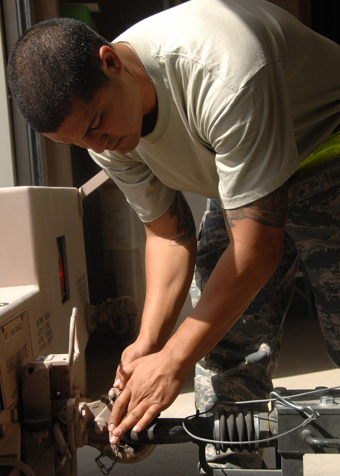 SOUTHWEST ASIA -- Senior Airman Leon Belaustegui, assigned to the 386th Expeditionary Maintenance Squadron munitions flight, hooks up a munitions trailer to a bobtail for transport to the flightline on Oct. 10 at an air base in Southwest Asia. The 386th EMXS munitions flight provides 24-hour munitions support to all flying operations and consists of five consolidated sections:  Munitions Operations, Conventional Maintenance, Stockpile Surveillance, Equipment Maintenance and Flightline Delivery. Airman Belaustegui is deployed from Charleston Air Force Base, S.C. (U.S. Air Force photo/Tech. Sgt. Raheem Moore)
