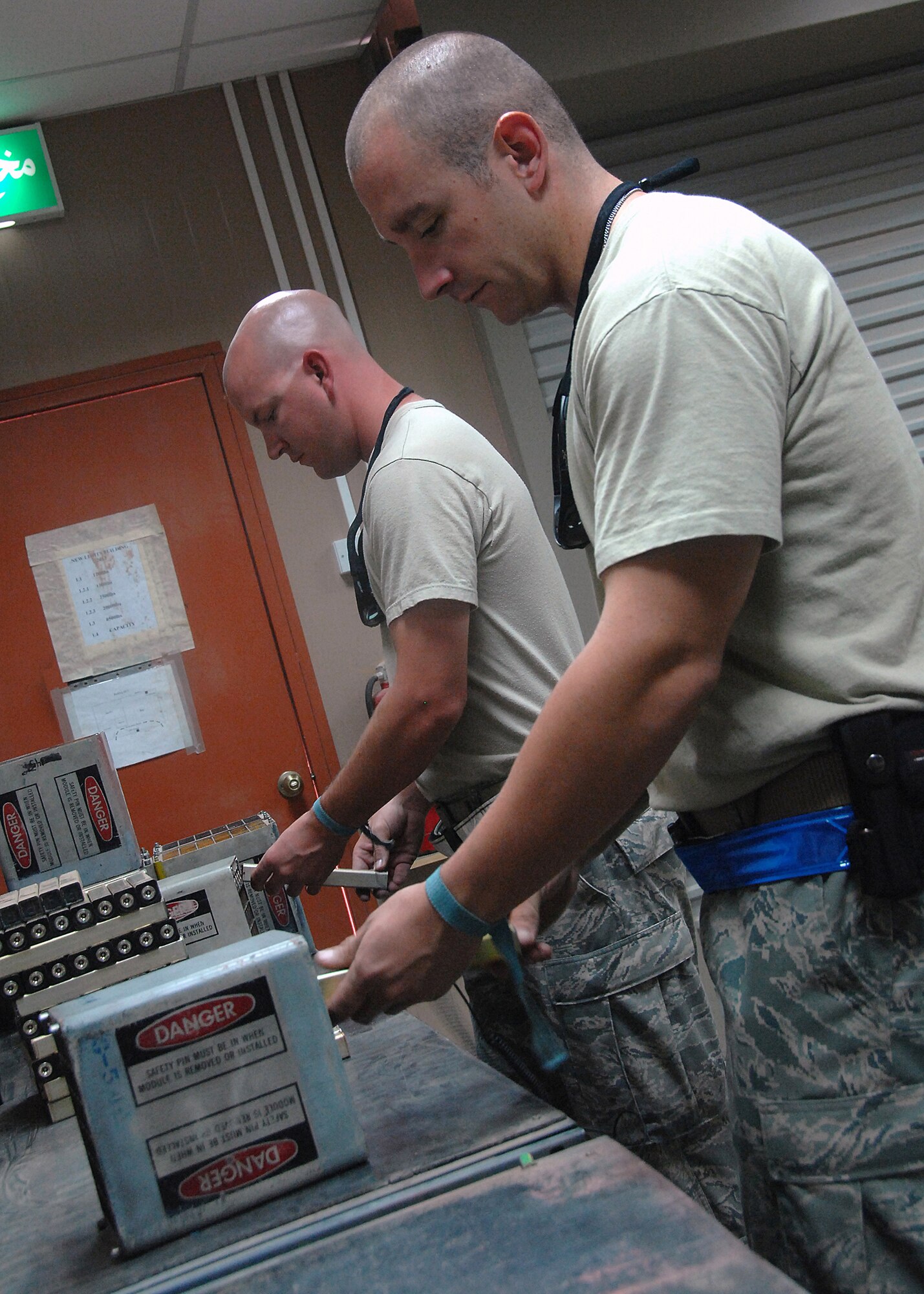 SOUTHWEST ASIA -- Staff Sgts. David Neil (front) and Evan Ray, both assigned to the 386th Expeditionary Maintenance Squadron munitions flight, load flares into a dispenser for transport to a C-130 Hercules on Oct. 10 at an air base in Southwest Asia. The 386th EMXS munitions flight provides 24-hour munitions support to all flying operations and consists of five consolidated sections:  Munitions Operations, Conventional Maintenance, Stockpile Surveillance, Equipment Maintenance and Flightline Delivery. Sergeants Neil and Ray are both deployed from Luke Air Force Base, Ariz. (U.S. Air Force photo/Tech. Sgt. Raheem Moore)