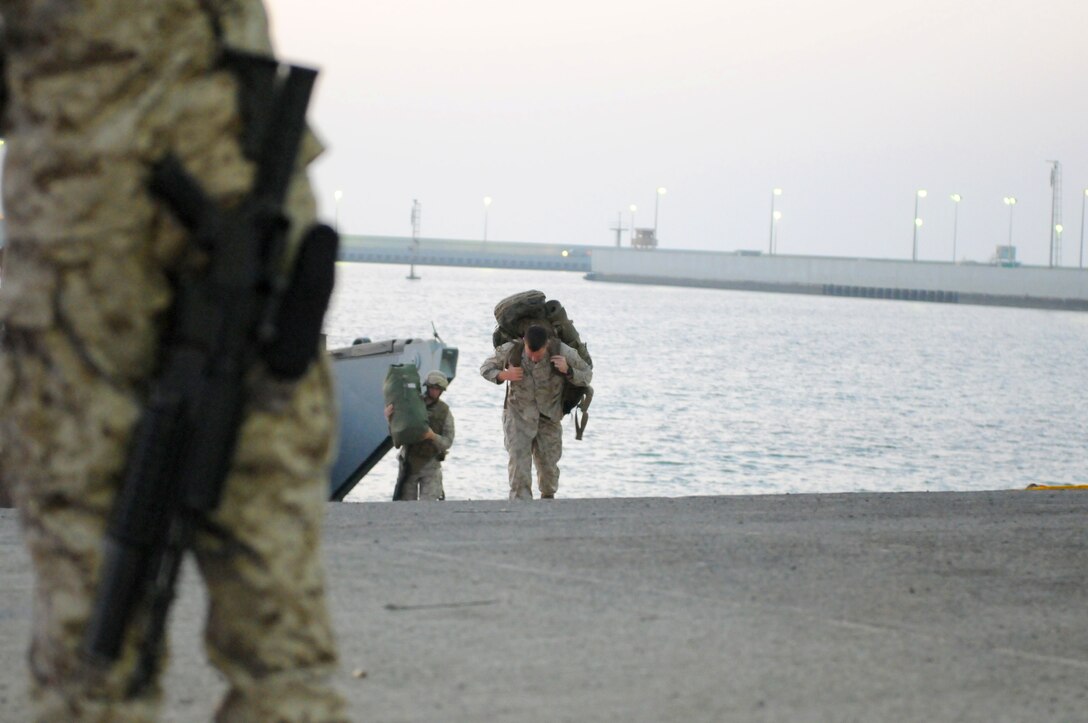 Marines from the 26th Marine Expeditionary Unit offload their gear from a Landing Craft Utility Oct. 12. The Navy and Marine Corps use LCUs to transport cargo, vehicles and troops from amphibious assault ships to beachheads or piers.