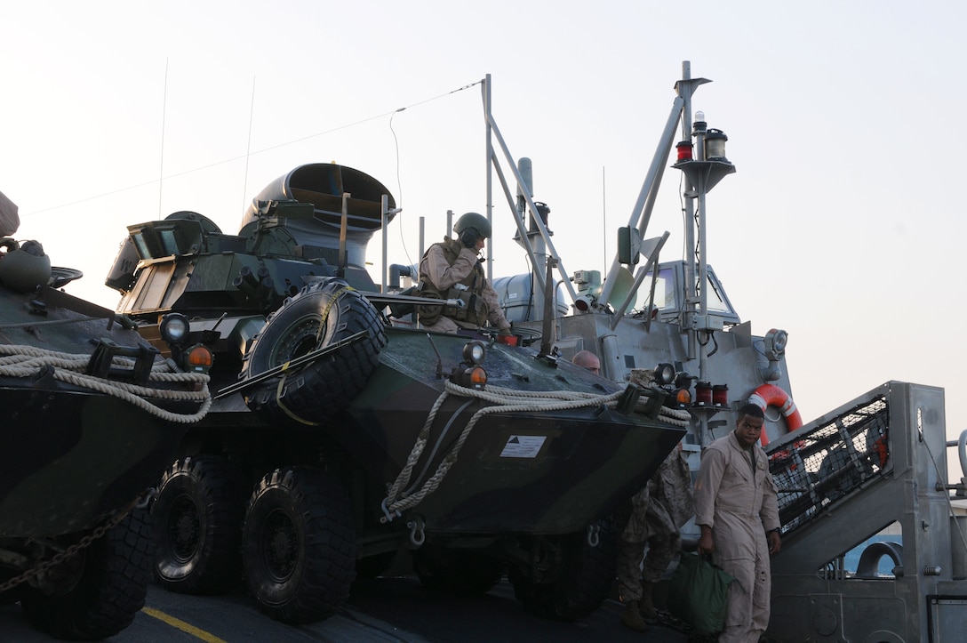 Marines from the 26th Marine Expeditionary Unit prepare to offload Light Armored Vehicles here Oct. 12. The LAV's anticipated retirement date was 2005, but through service life extension programs, the LAV is now expected to serve the Corps until at least 2024.
