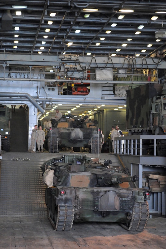 Two M-1A1 Abrams Main Battle Tanks stand ready to be loaded on a Landing Craft Air Cushioned amphibious vehicle off the coast of Kuwait Oct. 12. The tanks were aboard the USS San Antonio, host to the 26th Marine Expeditionary Unit.