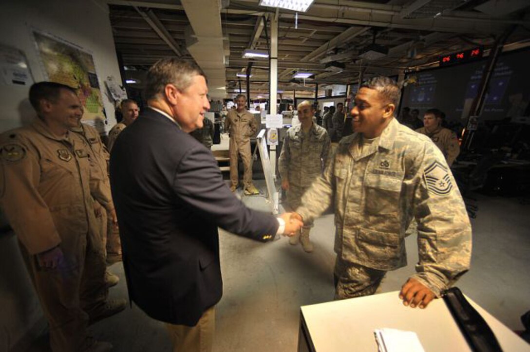 Secretary of the Air Force meets Senior Master Sgt. Timothy Davis inside the Combined Air and Space Operations Center Oct. 11. The CAOC provides the command and control of airpower throughout Iraq, Afghanistan and 25 other nations, extending from Central Asia to the Horn of Africa. (U.S. Air Force photo/Staff Sgt. Aaron Allmon)