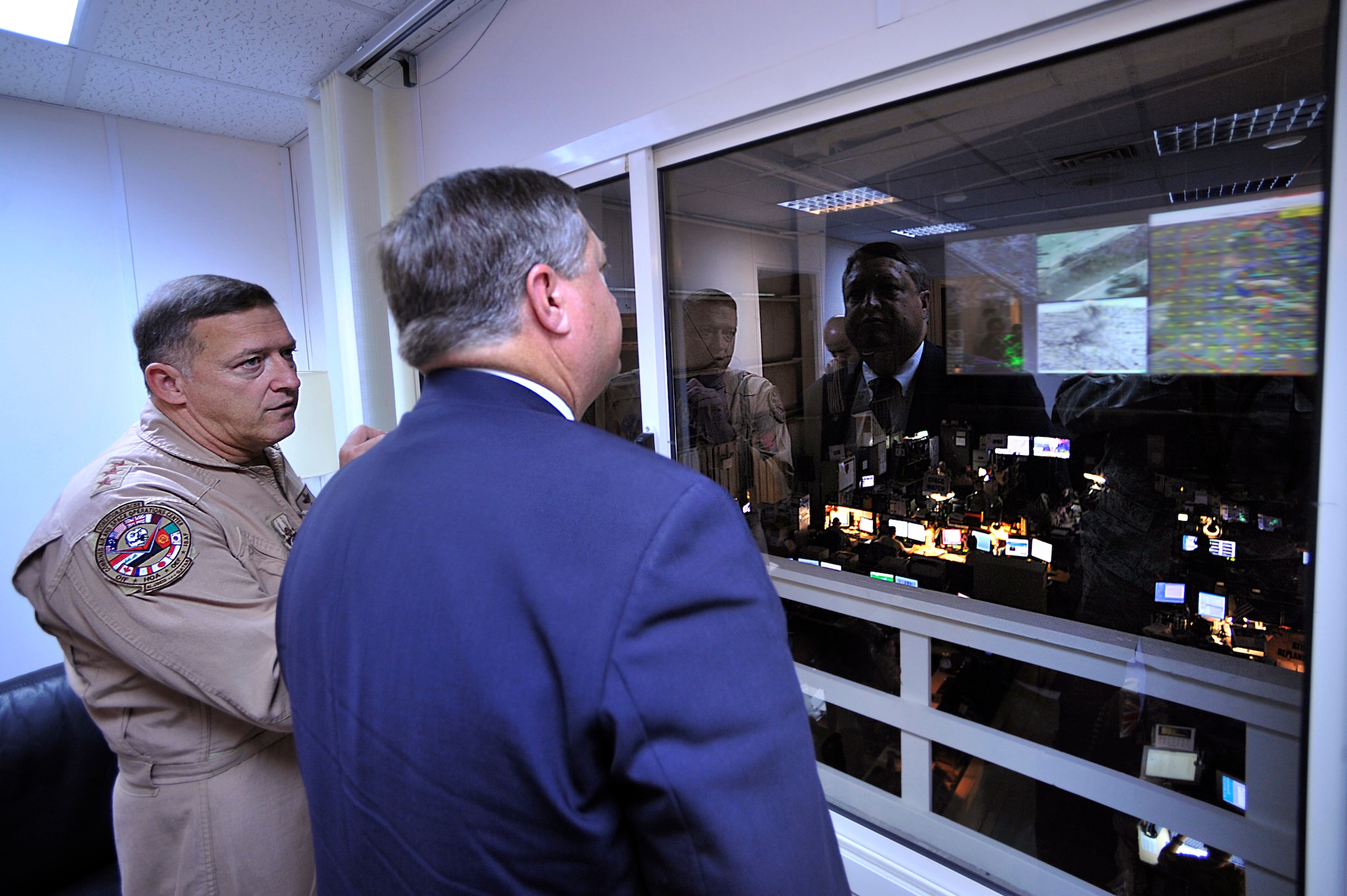 Lt. Gen. Gary North, Combined Forces Air Component commander, U.S. Central Command, discusses the integration and synchronization of airpower Oct. 11 as Air Force Secretary Michael Donley overlooks the operations floor of the Combined Air and Space Operations Center located in Southwest Asia. (U.S. Air Force photo/Staff Sgt. Aaron Allmon)