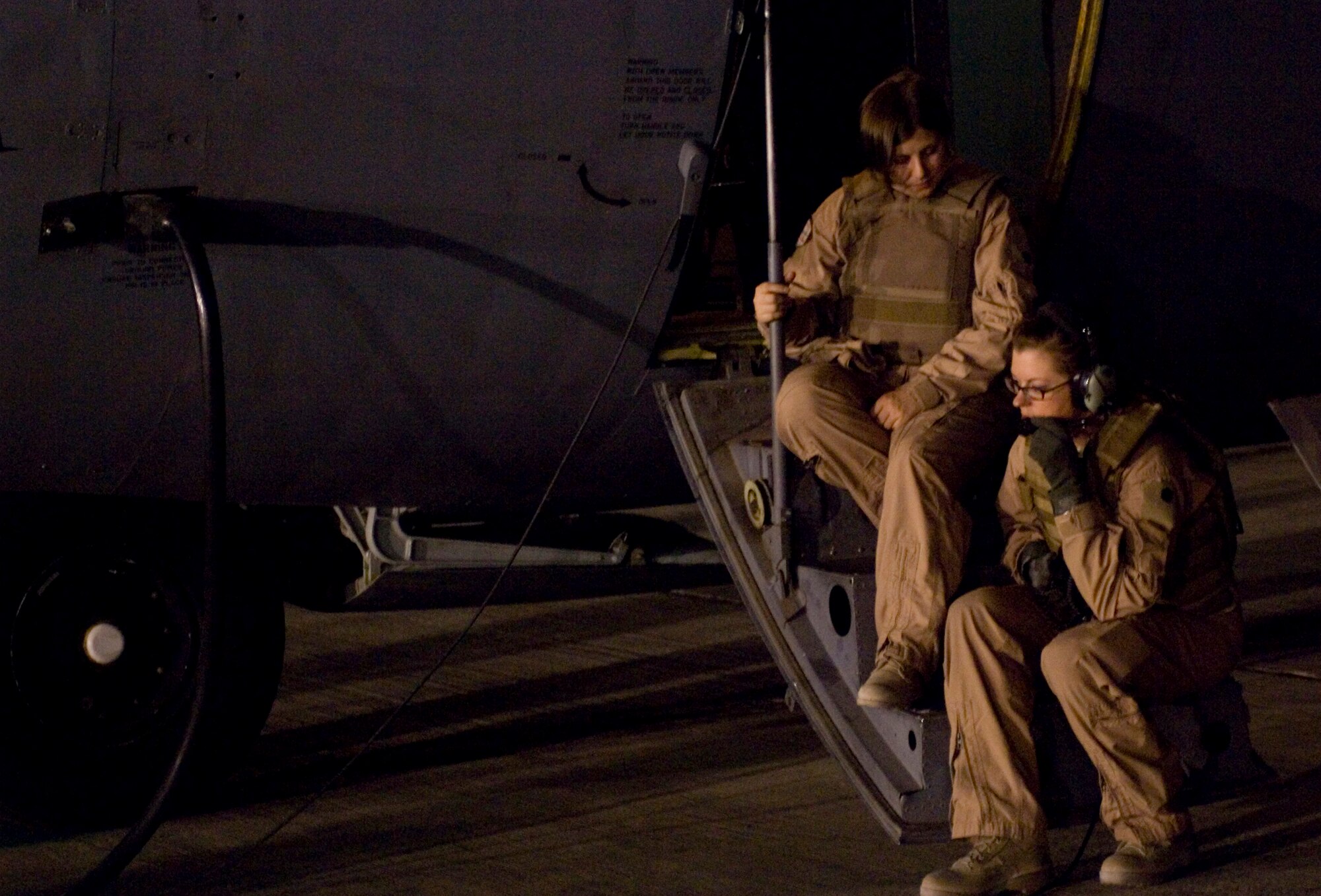 Tech. Sgt. Christy Calvert, right, and Senior Airman Sarah McRae, left, both from the 41st Expeditionary Electronic Combat Squadron, talk prior to flying a mission at Bagram Air Field, Afghanistan, Oct. 6. Since March 2004, the 41st EECS, deployed from Davis-Monthan Air Force Base, Ariz., has flown more than 10,000 with the EC-130H Compass Call in support of Operation Enduring Freedom. (U.S. Air Force photo by Staff Sgt. Rachel Martinez/Released)