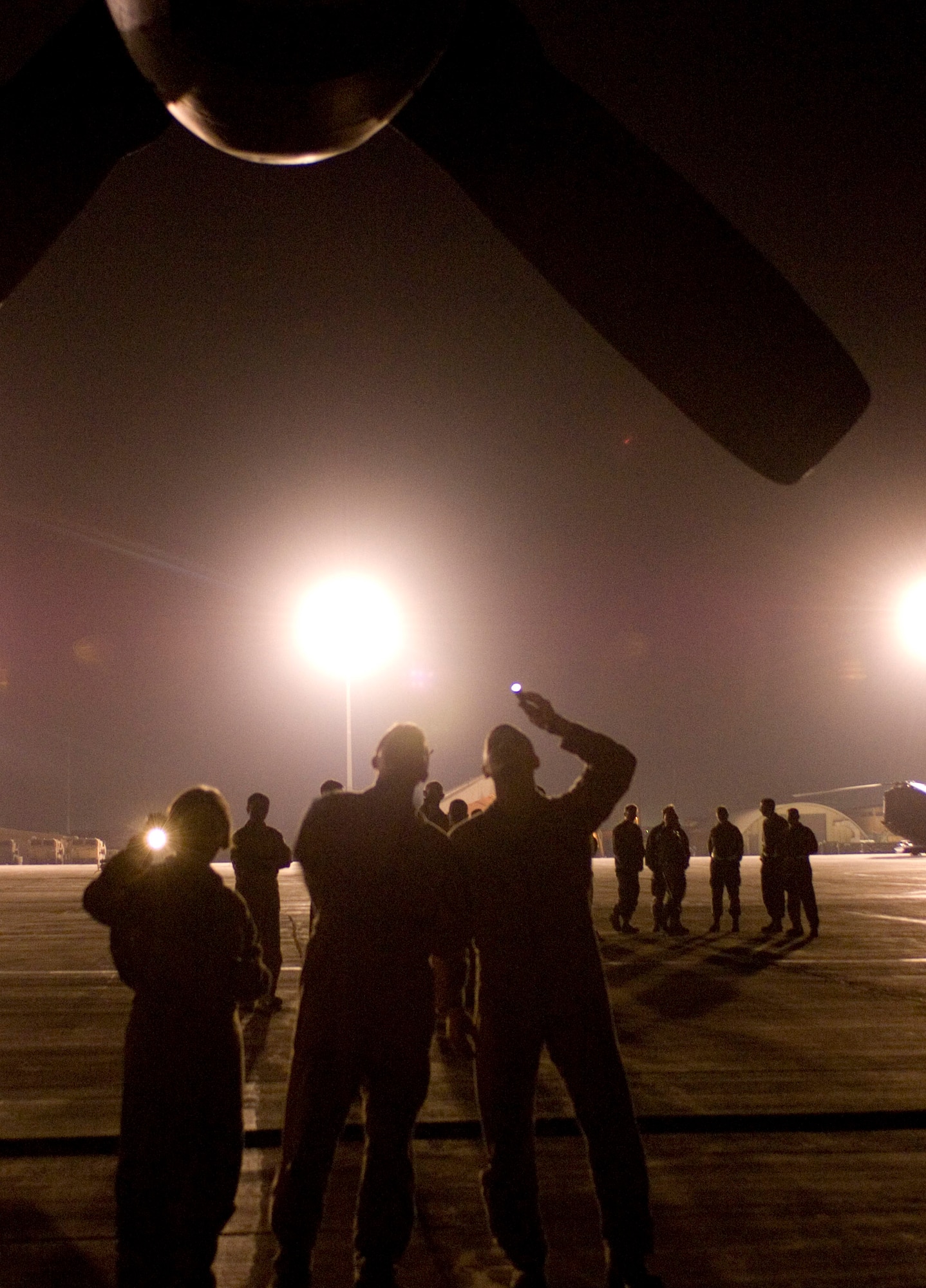 Aircrew members perform a pre-flight inspection on an EC-130H Compass Call while maintainers wait in the background to help launch the aircraft at Bagram Air Field, Afghanistan, Oct. 6. The 41st Expeditionary Electronic Combat Squadron recently surpassed 10,000 combat hours in support of Operation Enduring Freedom. (U.S. Air Force photo by Staff Sgt. Rachel Martinez/Released)