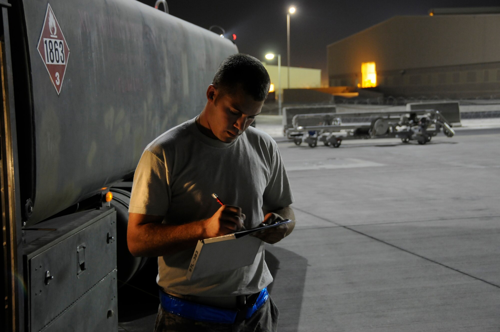 Senior Airman Dustin Stanley, 379th Expeditionary Logistics Readiness Squadron, fills out the paper work for a load of fuel October 10, 2008, at an undisclosed air base in Southwest Asia.  Airman Stanley, a native of Baker, Fla., is deployed from Moody Air Force Base, Ga., in support of Operations Iraqi and Enduring Freedom and Joint Task Force-Horn of Africa.  (U.S. Air Force photo by Tech. Sgt. Michael Boquette/Released)
