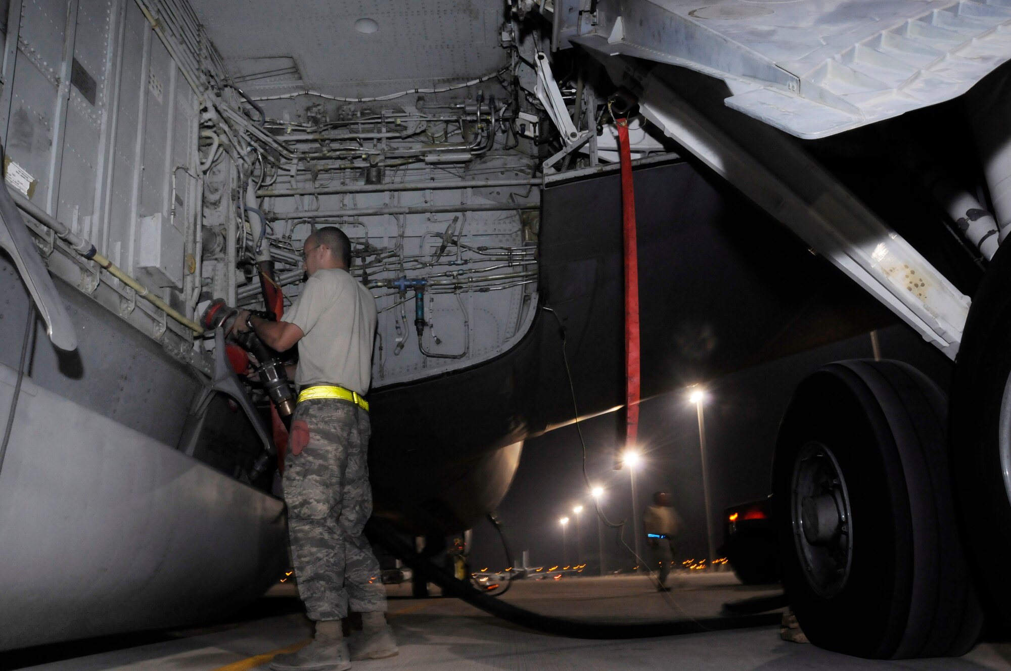 Senior Airman Benjamin Braithwaite, 379th Expeditionary Aircraft Maintenance Squadron, 340th Aircraft Maintenance Unit, connects a fuel hose to a KC-135 Stratotanker October 10, 2008, at an undisclosed air base in Southwest Asia.  KC-135s provide the core aerial refueling capability for the United States Air Forces Central forces supporting Operations Iraqi and Enduring Freedom and Joint Task Force-Horn of Africa.  Airman Braithwaite, a native of Germantown, Md., is deployed from Grand Forks Air Force Base, N.D.  (U.S. Air Force photo by Tech. Sgt. Michael Boquette/Released)