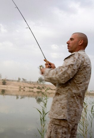 Master Sgt. Troy Buss a 43-year-old Bonduel, Wis. native, operations chief, Weapons Co., Task Force 1st Battalion, 3rd Marine Regiment, Regimental Combat Team 1, attempts to snag a potential catch during his weekly Sunday morning fishing trip, October 12, Karmah, Iraq. Although Karmah is one of the most active and desirable location for insurgents, due to its location, Iraqi Security Forces have been proactive in fending off threats and locating weapons caches. Keeping in nature of the conflict, as Coalition Forces begin limiting their presence, allowing Marines an hour, if that, to themselves on an early Sunday morning. (U.S. Marine Corps photo by Lance Cpl. Achilles Tsantarliotis)