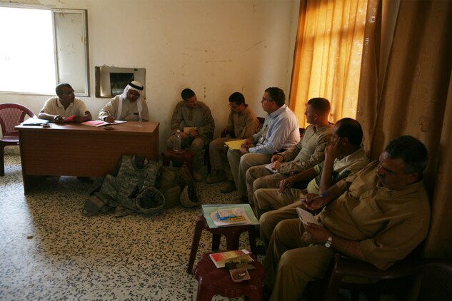 Members of the Tri-Cities City Council discuss current and future reconstruction projects, Oct. 12. Governance advisers with Mobile Assault Company, Task Force 1st Battalion, 2nd Marine Regiment, Regimental Combat Team 1, were present to facilitate discussions between the city council and a representative from the Embedded Provision Reconstruction Team - Ramadi. (Official U.S. Marine Corps Photo) (Released)