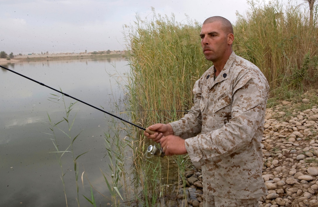 Master Sgt. Troy Buss, the 43-year-old operations chief with Company W, 1st Bn., 3rd Marines, from Bonduel, Wis., casts a line on an early Sunday morning before heading to work, minutes from his lakeside fishing spot. Buss grew up fishing, and with a lake so close, and operational tempo so permitting, Buss takes the opportunity of relieving stress as the sun rises on Sundays. (USMC photo by Lance Cpl. Achilles Tsantarliotis)
