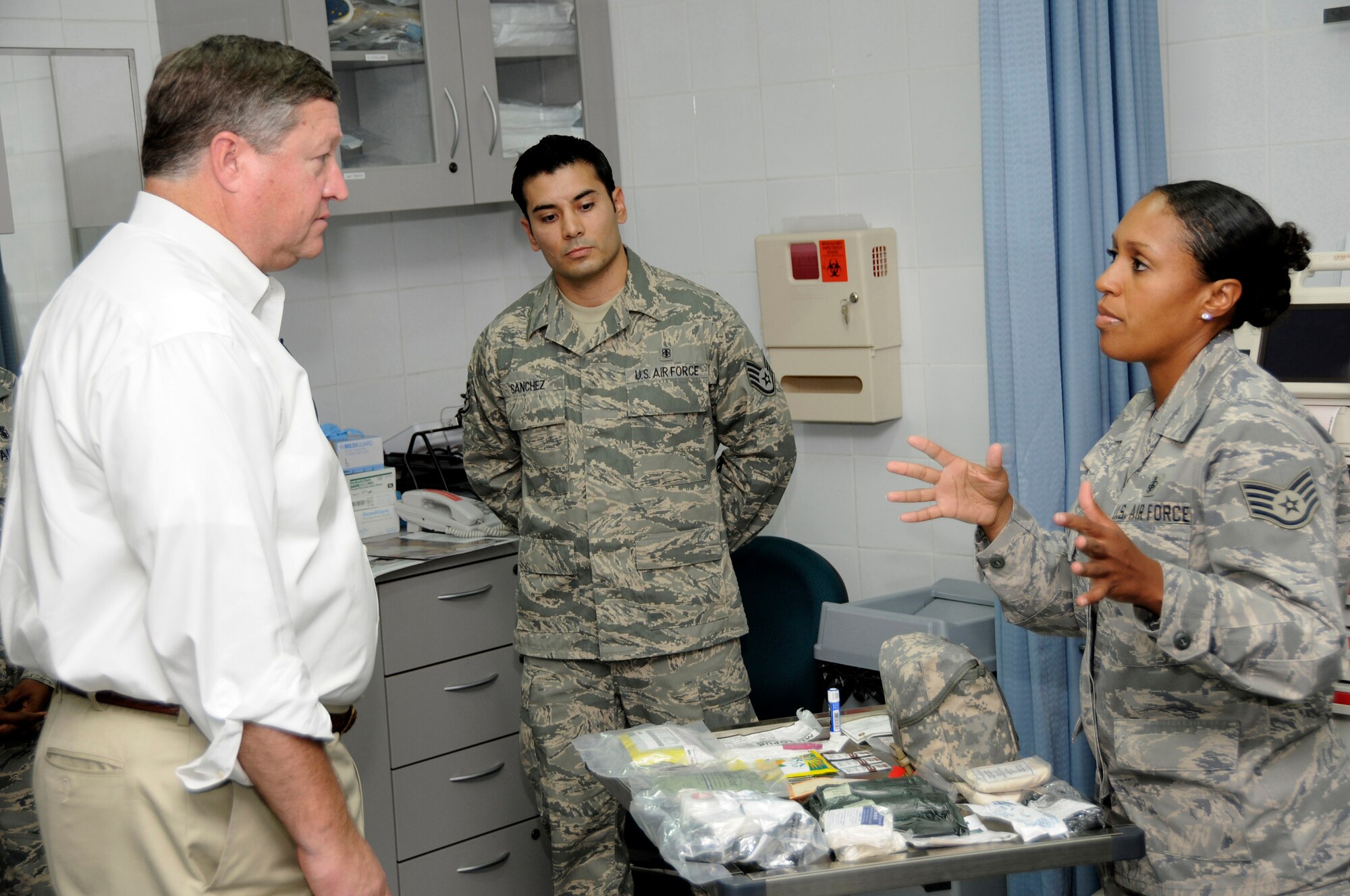 Staff Sgt. Lizeth Cameron, 379th Expeditionary Medical Group, briefs Secretary of the Air Force Michael Donley on the Individual First Aid Kit recertification process October 11, 2008.  Sergeant Cameron described how the 379 EMDG and the 379th Expeditionary Logistics Readiness Squadron team together to inspect, replenish and distribute IFAKs for the entire Air Forces Central area of responsibility. (U.S. Air Force photo by Tech. Sgt. Michael Boquette/Released)