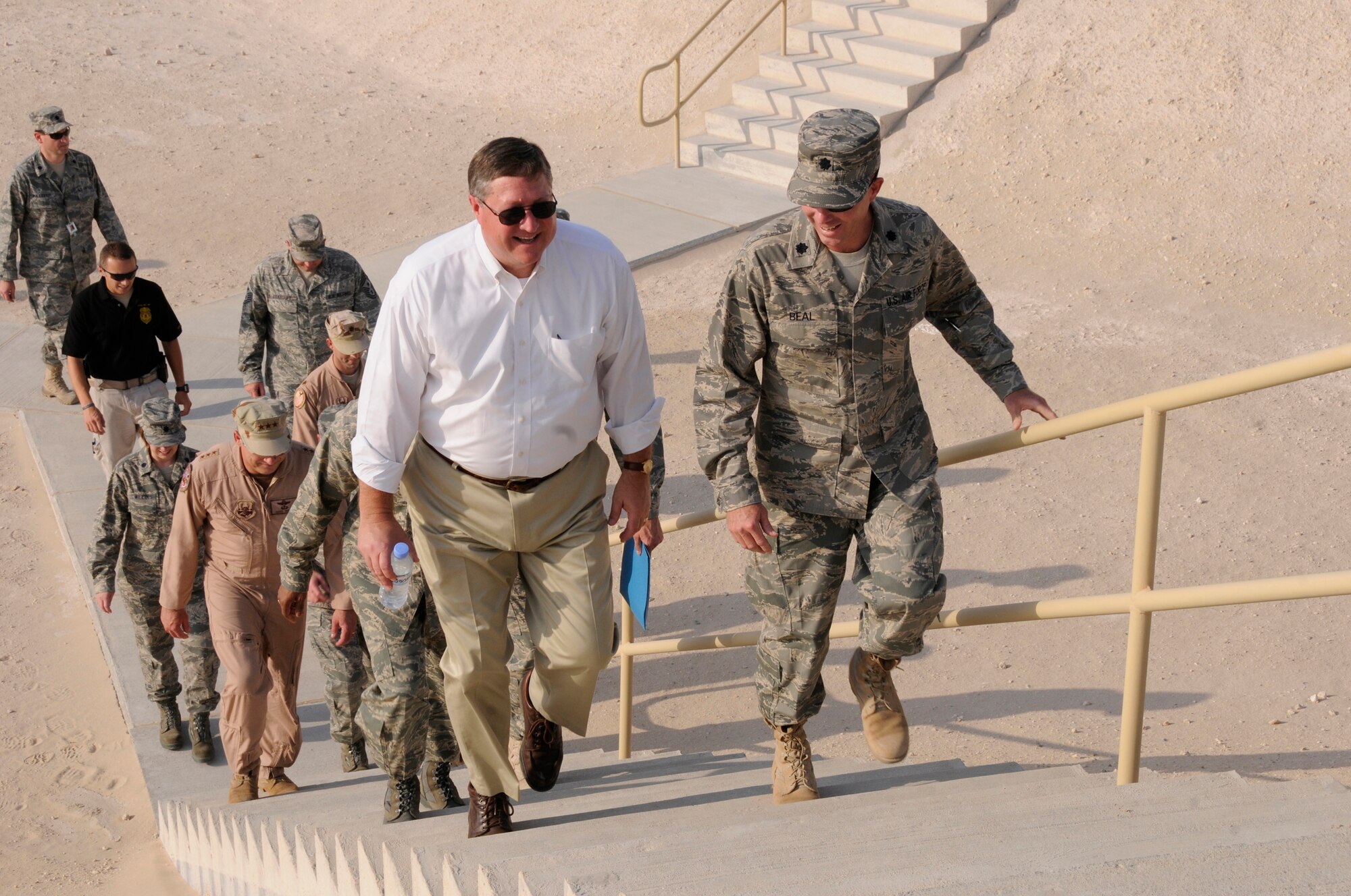 Lt. Col. Colin Beal, commander of the 379th Expeditionary Logistics Readiness Squadron, escorts Secretary of the Air Force Michael Donley to the top of a fuel storage area here, October 11, 2008.  The secretary was briefed on ongoing and future construction projects and the critical role the 379 ELRS fuels team plays in enabling missions in support of Operations Iraqi and Enduring Freedom and Joint Task Force-Horn of Africa.  (U.S. Air Force photo by Tech. Sgt. Michael Boquette/Released)