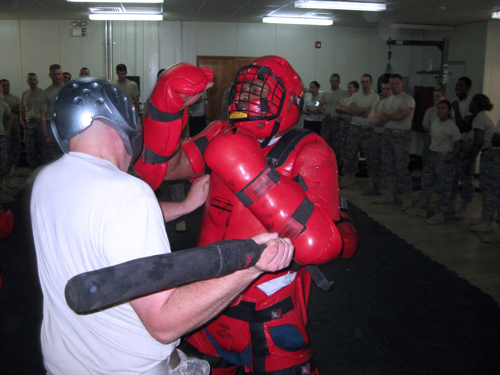 SOUTHWEST ASIA -- Staff Sgt. Bill Ayres, 386th Expeditionary Security Forces Squadron, practices defending himself with an expandable baton against Staff Sgt. Wayne Gatewood, 386th ESFS, during a self-defense training course at an air base in Southwest Asia. Force protectors perform numerous tasks while deployed to the U.S. Central Command area of responsibility, including escort duties and base project support.