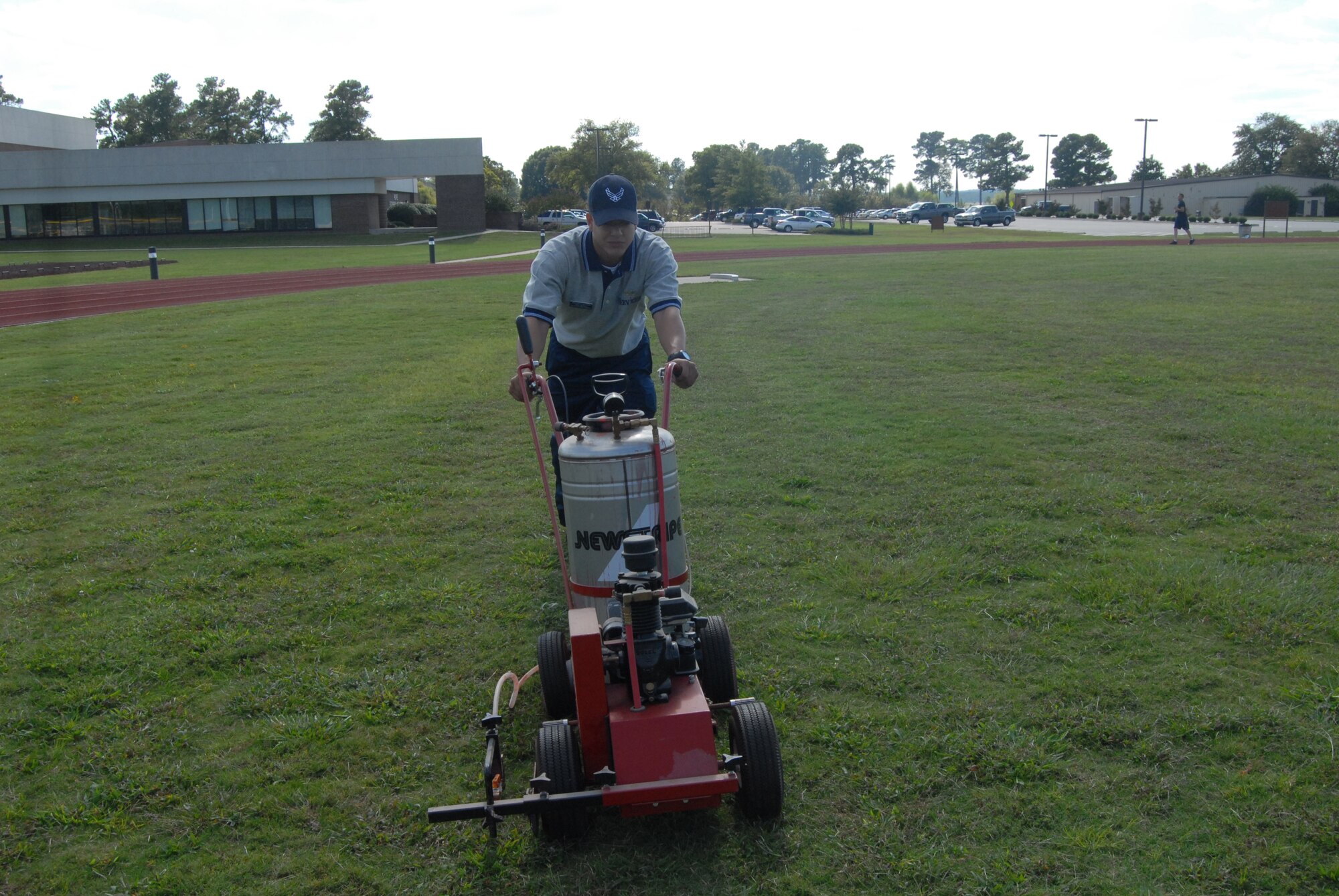 Senior Airman Christian Pagan, 43rd Force Support Squadron, prepares to mark the fitness center’s football field Oct. 1 for the intramural football season. (U.S. Air Force Photo by Staff Sgt. Jon LaDue)