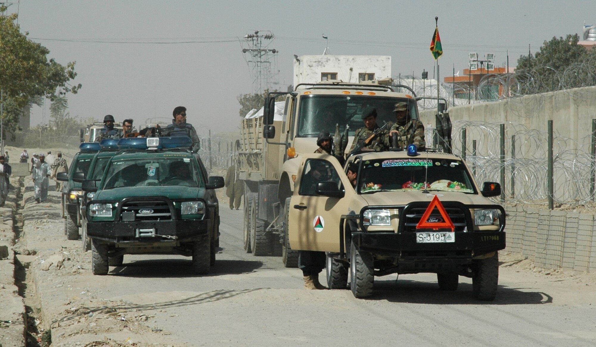 Afghan National Army and Police troops provide security as 260 metric tons of winter wheat seed travels throughout Zabul province, Sept. 14. ANA and ANP teamed up with coalition forces to ensure the seed’s safe delivery.