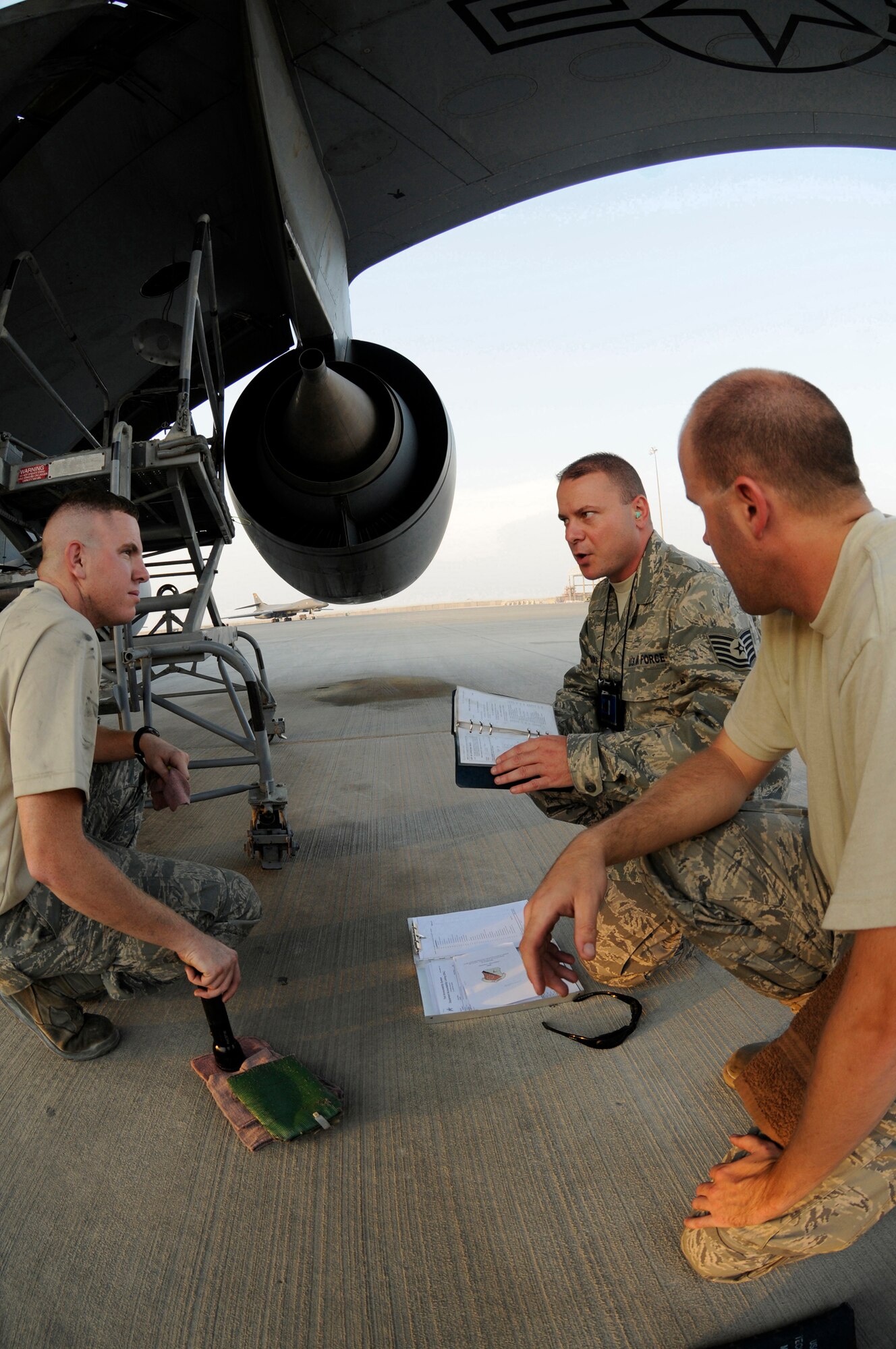 Tech. Sgt. Timothy Sparks, quality assurance inspector assigned to the 379th Expeditionary Maintenance Group, conducts a technical data use and KC-135 Stratotanker technical order currency inspection with Staff Sgt. Dustin Garneau and Staff Sgt. Matthugh Crosby, Oct. 12, 2008, at an undisclosed air base in Southwest Asia.  Sergeants Garneau and Crosby are both hydraulics specialists assigned to the 379th Expeditionary Aircraft Maintenance Squadron. Sergeant Sparks, a native of Blount County, Ala., is deployed from Grand Forks Air Force Base, N.D.  Sergeant Garneau, a native of Moses Lake, Wash., is deployed from Fairchild AFB, Wash.  Sergeant Crosby, a native of Ocala, Fla., is deployed from MacDill AFB, Fla.  All are deployed in support of Operations Iraqi and Enduring Freedom and Joint Task Force-Horn of Africa. (U.S. Air Force photo by Staff Sgt. Darnell T. Cannady/Released)