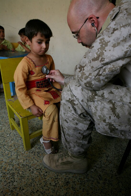 SATTACK, Iraq (October 13, 2008) – Navy Lt. Chris Owston, a Medical Officer with Task Force 1st Battalion, 2nd Marine Regiment, Regimental Combat Team 1, listens to an Iraq girl’s heart and lungs, Oct. 13. At the request of the local city council, Owston evaluated more than 40 children and was pleased to find no signs of malnourishment or poor health. (Official U.S. Marine Corps photo by Lance Cpl. Scott Schmidt)