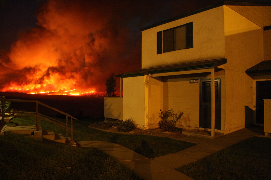 Wildfires burn nearby the Serra Mesa housing area on Marine Corps Base Camp Pendleton, Calif., Oct. 13.