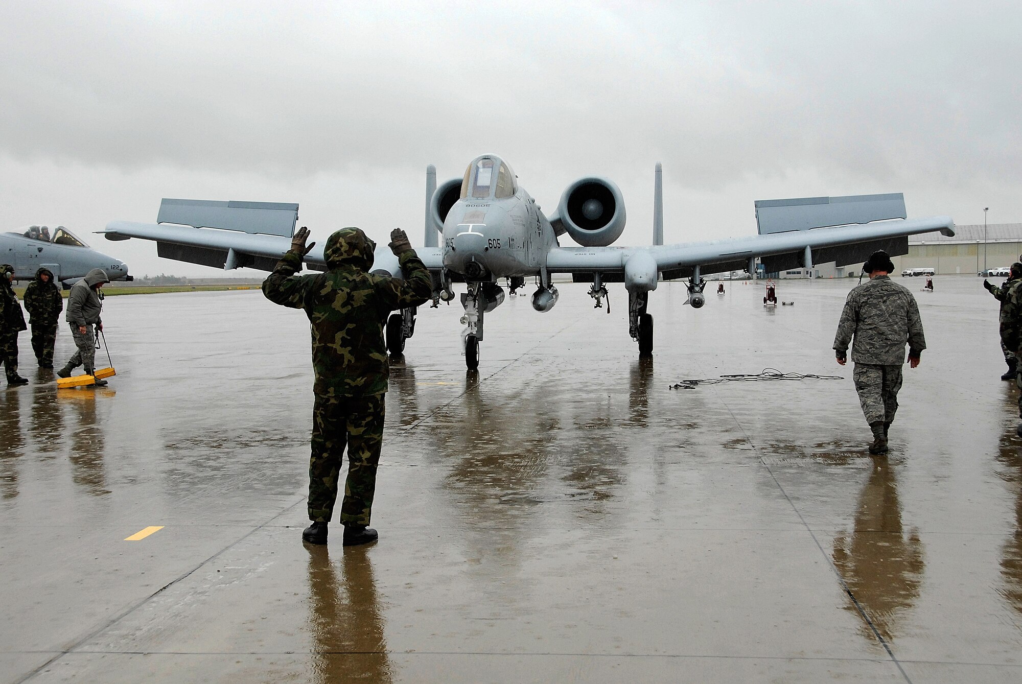 A 442nd Fighter Wing crew chief marshals in the first A-10 to arrive at Salina Airport; Kan., for the Air Force's Hawgsmoke 2008; a biennial A-10 bombing and tactical gunnery competition. The event, hosted by the 442nd FW's 303rd Fighter Squadron, tests A-10 pilots in flight leadership, target acquisition, weapons delivery. The 442nd FW is an Air Force Reserve Command unit based at Whiteman Air Force Base, Mo. (US Air Force photo/Master Sgt. Bill Huntington)