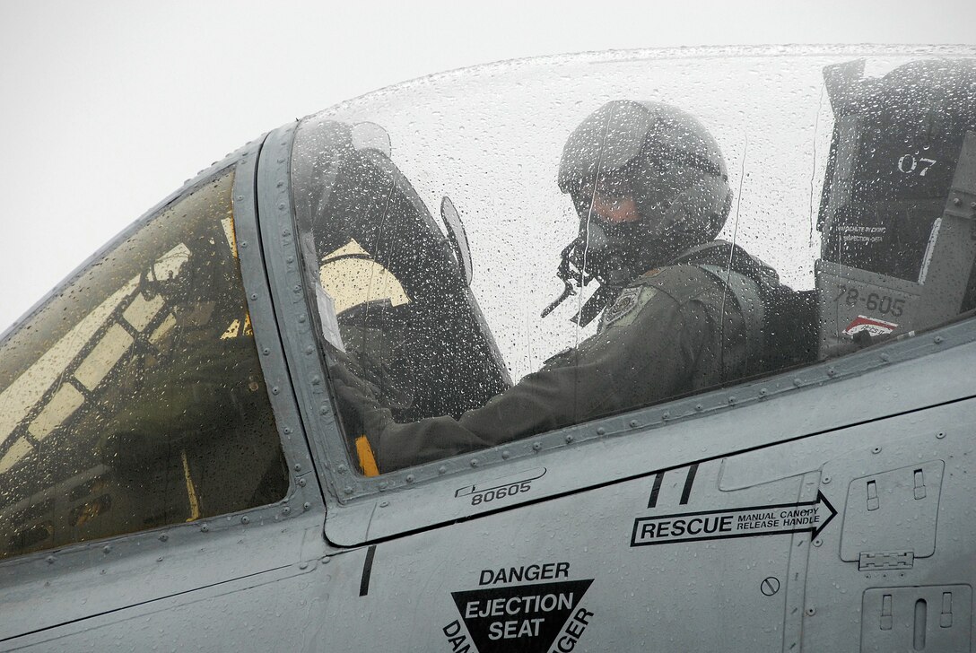 Maj. Preston McConnell, a 303rd Fighter Squadron A-10 Thunderbolt II pilot, waits for his crew chief to signal chocks-in on the first A-10 to arrive at Salina Airport; Kan., for the Air Force's Hawgsmoke 2008; a biennial A-10 bombing and tactical gunnery competition. The event, hosted by the 442nd FW's 303rd Fighter Squadron, tests A-10 pilots in flight leadership, target acquisition, weapons delivery. The 442nd FW is an Air Force Reserve Command unit based at Whiteman Air Force Base, Mo. (US Air Force photo/Master Sgt. Bill Huntington)