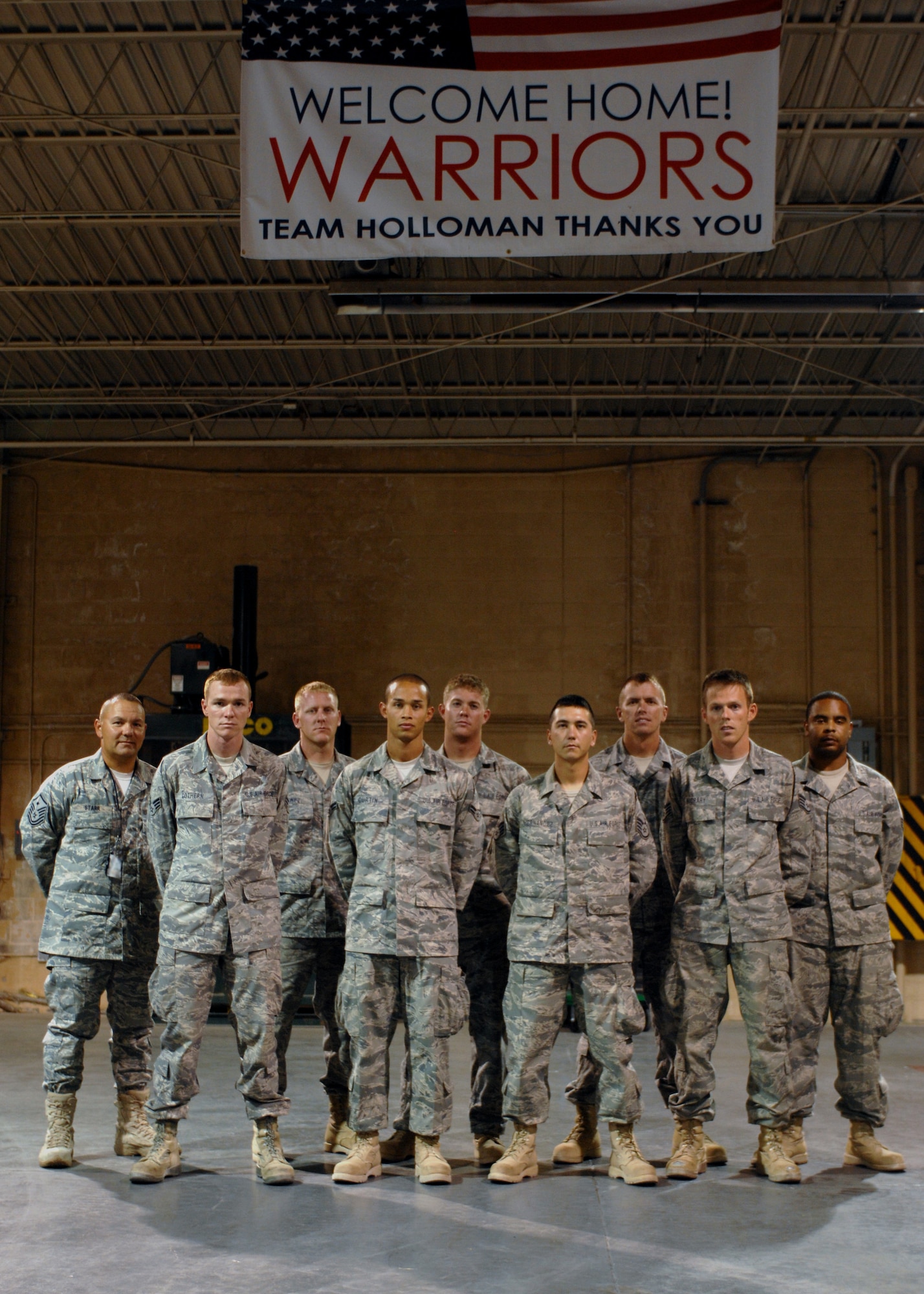 Eight members from the 49th Materiel Maintenance Group pose for a group photo in the weapons vault at Holloman Air Force Base, N.M., October 8. First Sergeant Master Sgt. Brian Starr, from the 49th Materiel Maintenance, welcomes home warriors after 64 days of deployment to Bahgram, Kandahar and Jalalabad. (U.S. Air Force photo/ Airman 1st Class Veronica Salgado)