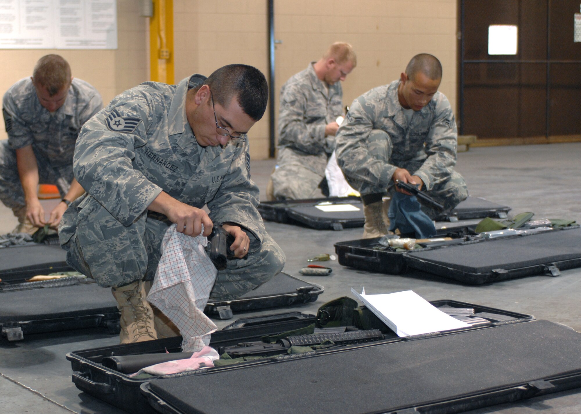 Members of the 49th Materiel Maintenance Group, clean their 9mm pistols before clearing them at the weapons vault, October 8. The J2 deployment team recently returned home to Holloman Air Force Base, N.M. after a 64 day deployment to Bahgram, Kandahar and Jalalabad. (U.S. Air Force photo/Airman 1st Class Veronica Salgado)
