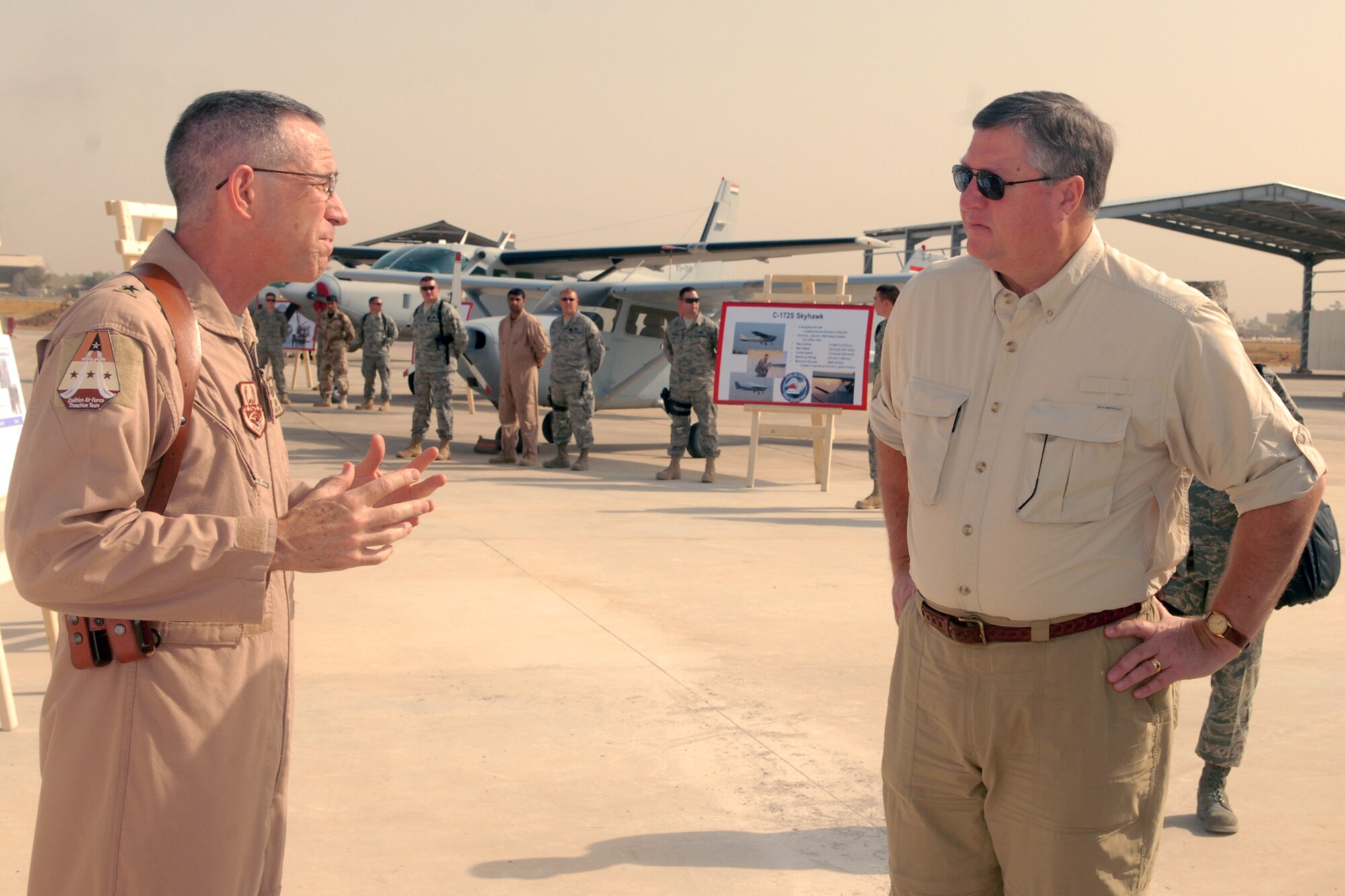 Brig. Gen. Brooks Bash, Coalition Air Force Transition Team commander, briefs Secretary of the Air Force Michael Donley about the CAFTT mission during his visit to Kirkuk Regional Air Base, Iraq, Oct. 14.  The secretary toured various facilities and spoke to Airmen about his vision for the overall mission within the AOR and the future of the Air Force. (U.S. Air Force photo/Senior Airman Randi Flaugh)