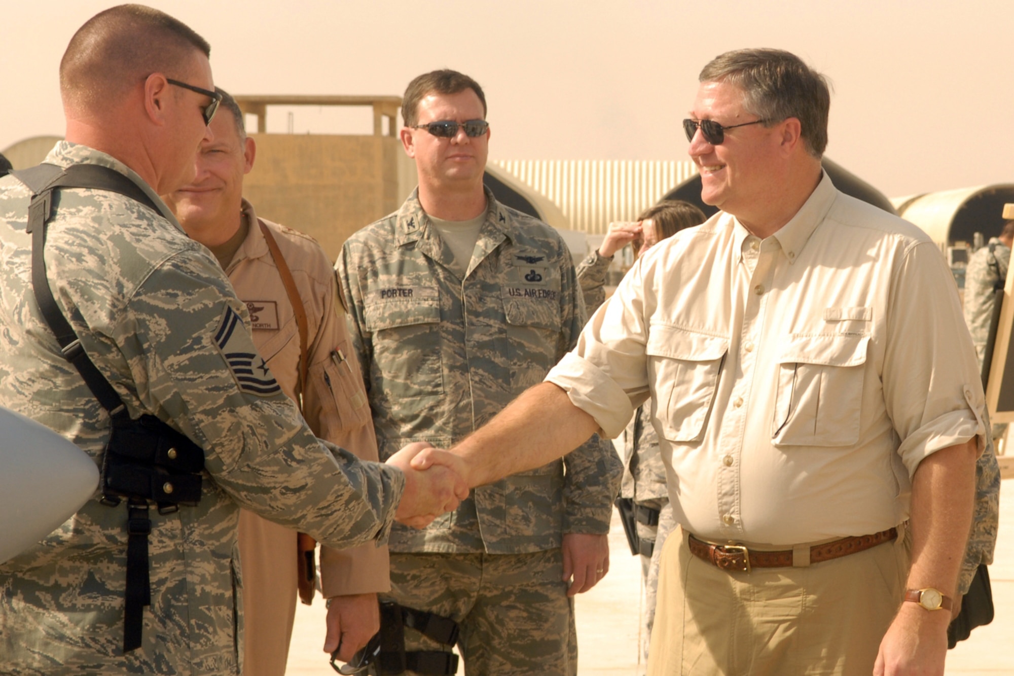 Senior Master Sgt. Gary Meacham, the 52nd Expeditionary Flying Training Squadron aerospace maintenance superintendent advisor at Kirkuk Regional Air Base, Iraq, greets Secretary of the Air Force Michael Donley during his visit Oct. 14.  The 52d EFTS operates fixed and rotary wing aircraft to provide ground and flight training for Iraqi pilot candidates, instructor pilots and maintenance officers in a combat environment.  The secretary toured various facilities and spoke to Airmen about his vision for the overall mission within the Southwest Asia AOR and the future of the Air Force.  Sergeant Meacham is deployed from Hill Air Force Base, Utah. (U.S. Air Force photo/Senior Airman Randi Flaugh)