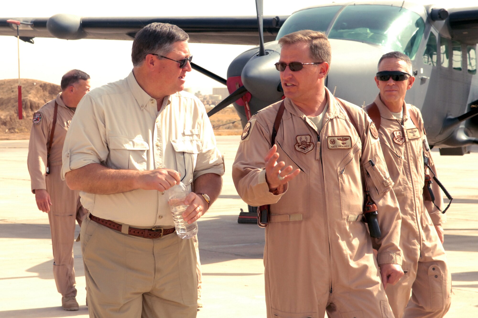 Lt. Col. Nathan Brauner, the 52nd Expeditionary Flying Training Squadron commander at Kirkuk Regional Air Base, Iraq, briefs Secretary of the Air Force Michael Donley about the squadron's mission during his visit here Oct. 14.  The 52d EFTS operates fixed and rotary wing aircraft to provide ground and flight training for Iraqi pilot candidates, instructor pilots and maintenance officers in a combat environment.  The secretary toured various facilities and spoke to Airmen about his vision for the overall mission within the Southwest Asia AOR and the future of the Air Force.  (U.S. Air Force photo/Senior Airman Randi Flaugh)
