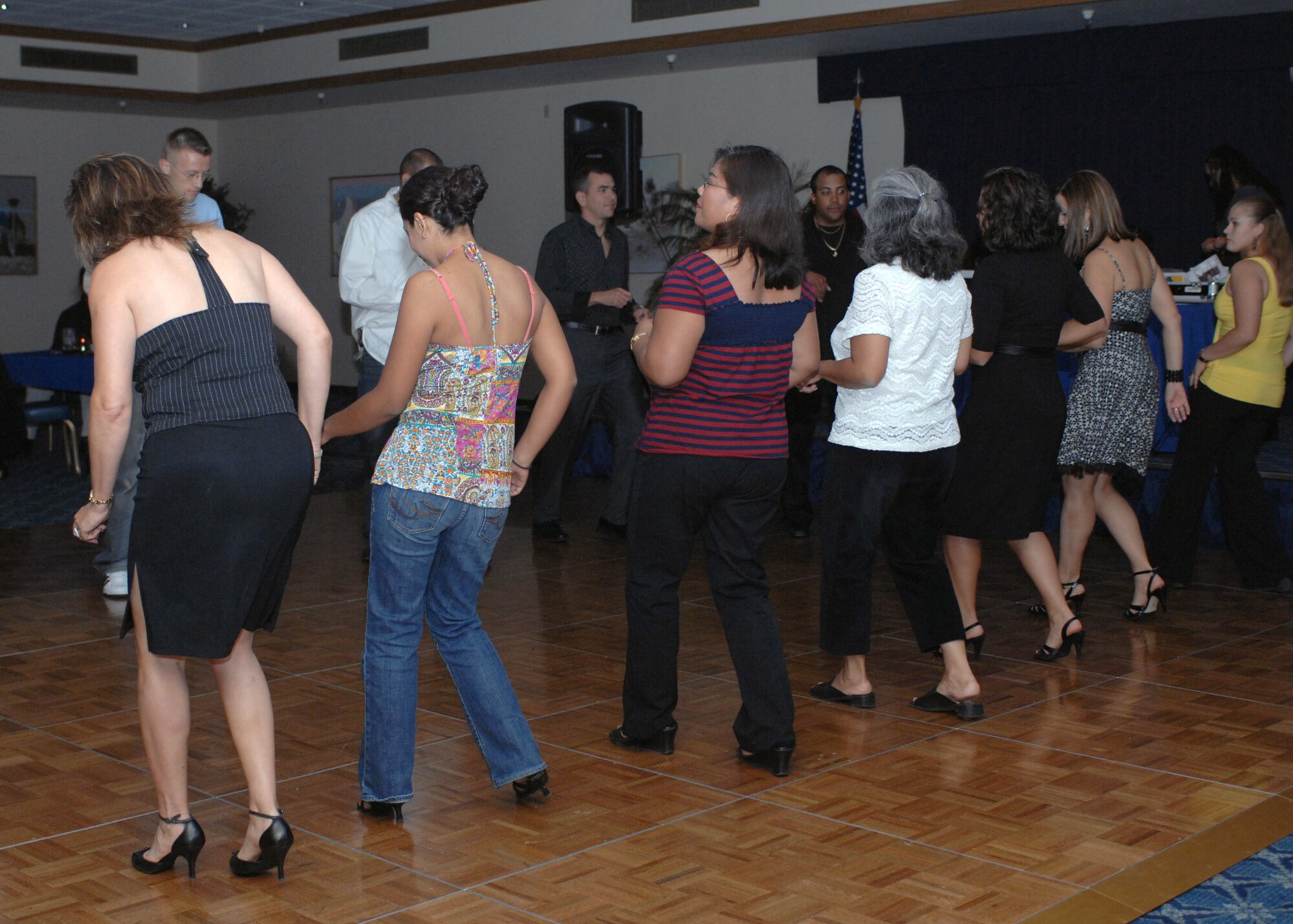 Guests that attended Latin Night, gathered together on the dancefloor to practice the basic movements of salsa and mambo, at Holloman Air Force Base, N.M., October 3. Latin Night was held at the Desert Sands Enlisted Club to celebrate Hispanic Heritage month. (U.S. Air Force photo/Airman 1st Class Veronica Salgado)         
