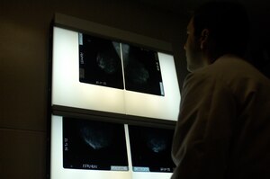 LANGLEY AIR FORCE BASE, Va. -- Maj. Jason Morvant, chief of surgery at the 1st Fighter Wing Hospital, examines mammogram films.  Annual mammograms are key in helping doctors detect and diagnose breast cancer in patients.  Both annual mammograms and monthly self-breast examinations play important roles in prevention and early detection of the disease. (U.S. Air Force photo/Airman 1st Class Sylvia Olson)