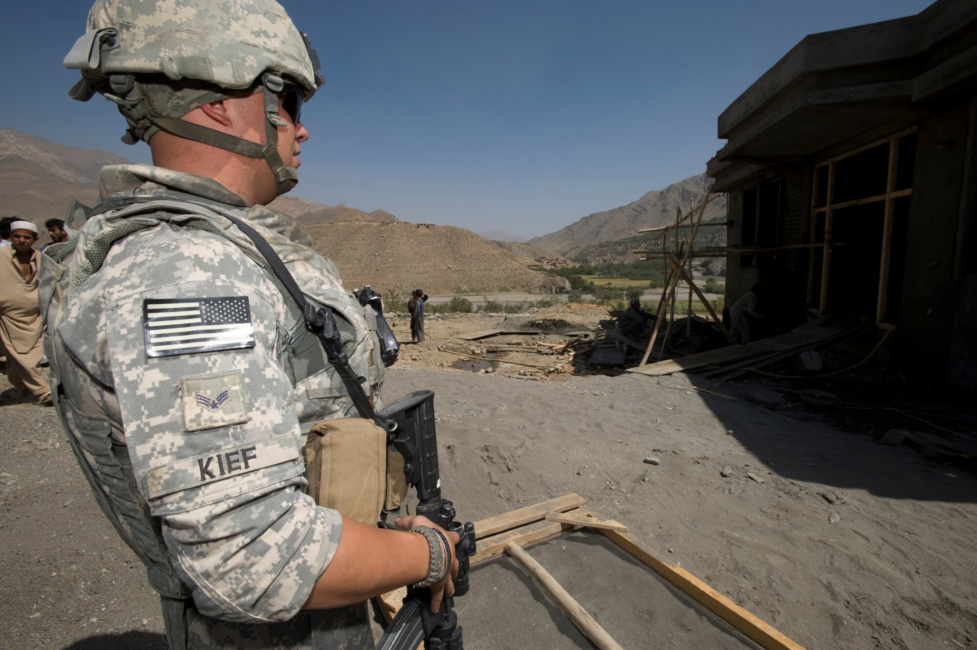 Senior Airman Andrew Kief examines the progress of construction on a new clinic in a small Afghanistan village recently. Airman Kief served as the convoy commander for this mission and was responsible for coordinating meeting times and setting up the missions agenda. Airman Kief is a Kapisa and Parwan Provincial Reconstruction Team security forces member. (U.S. Air Force photo/Master Sgt. Keith Brown) 
