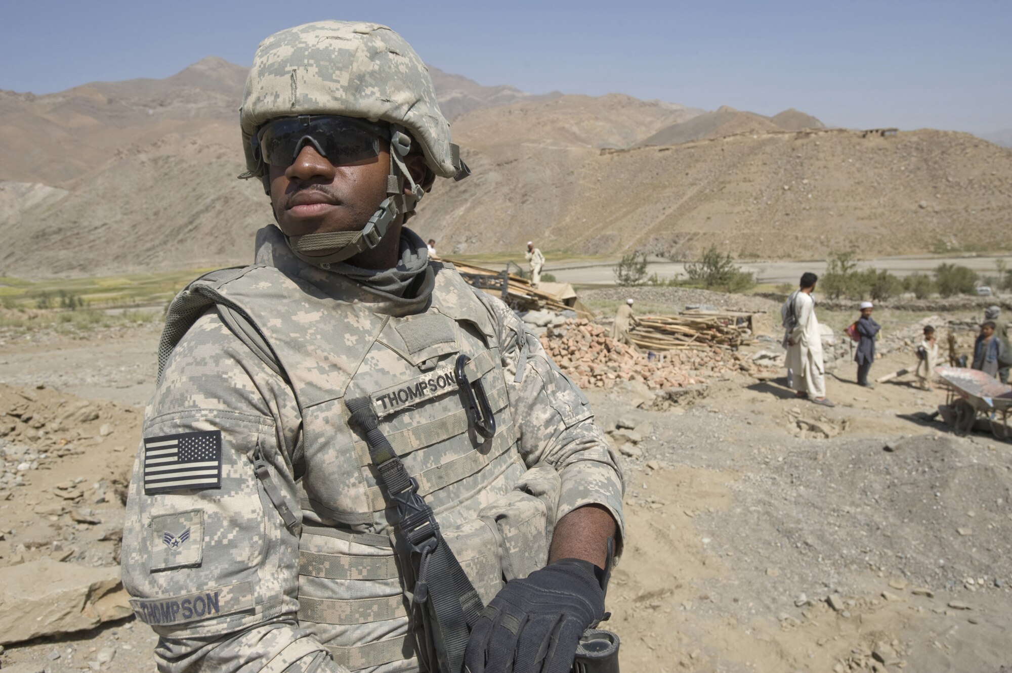 Senior Airman Courtney Thompson stands guard as fellow team members operate a makeshift medical clinic in an isolated Afghan village. The joint-service team has members from the Air Force, Army and Navy assigned to it. Airman Thompson is assigned to the Kapisa and Parwan Provincial Reconstruction Team, Ill. (U.S. Air Force photo/Master Sgt. Keith Brown) 
