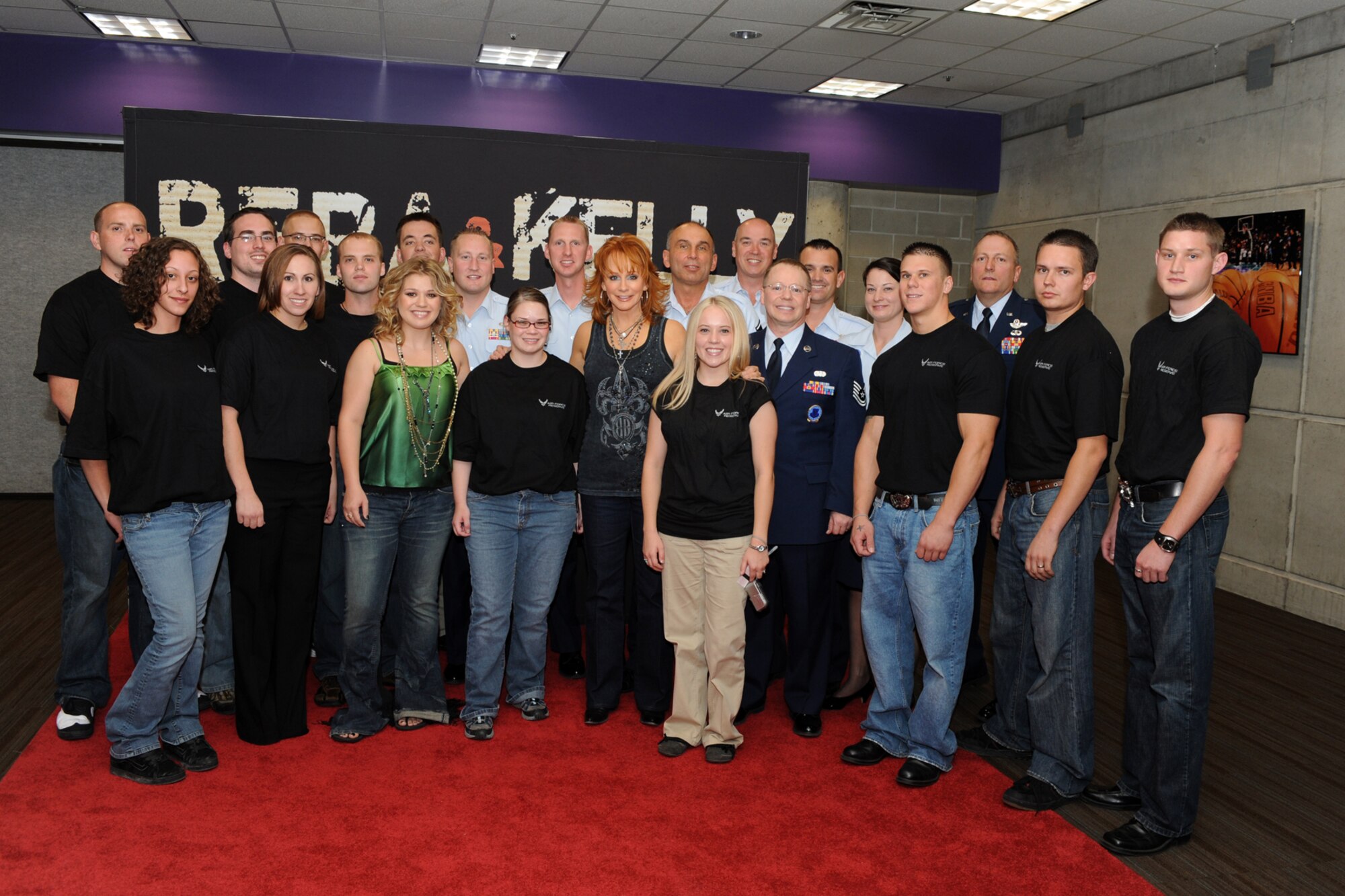 New recruits to the Air Force Reserve and the 419th Fighter Wing pose with multiplatinum recording artists Reca McEntire and Kelly Clarkson just following a mass enlistment ceremony on stage at the EnergySolutions Arena in Salt Lake City Friday. (U.S. Air Force photo/James Arrowood)