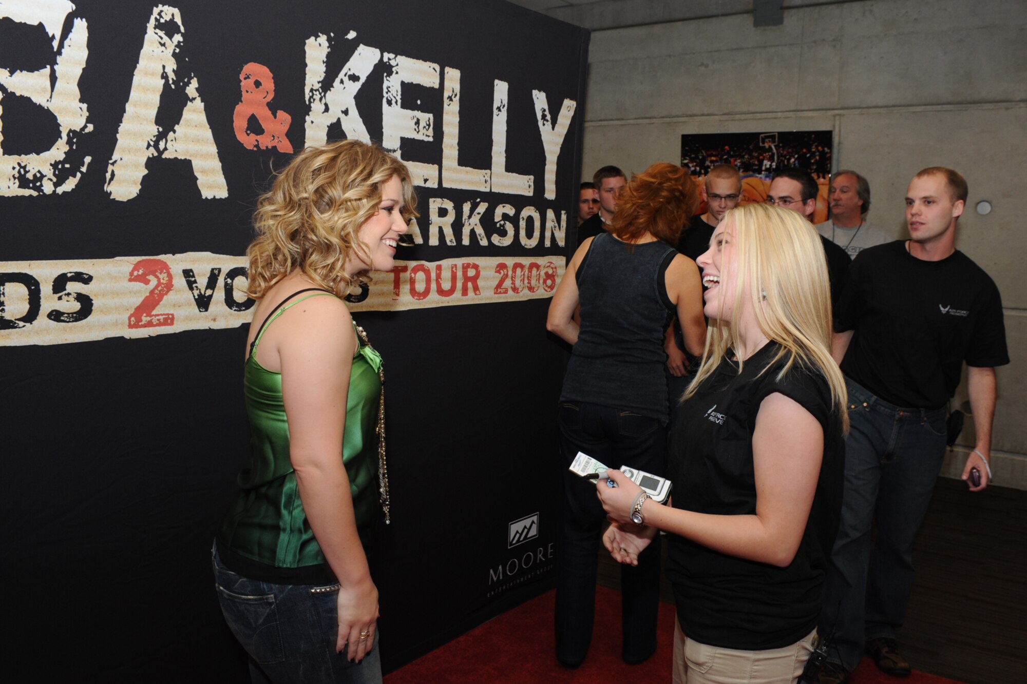 Kelly Clarkson, multiplatinum recording artist and winner of the first installment of "American Idol," chats with Air Force Reserve enlistee Camaree Sargent in a meet-and-greet session for the new 419th Fighter Wing recruits. Fourteen men and women enlisted on stage at the EnergySolutions Arena in Salt Lake City Friday before thousands of onlookers. (U.S. Air Force photo/James Arrowood)